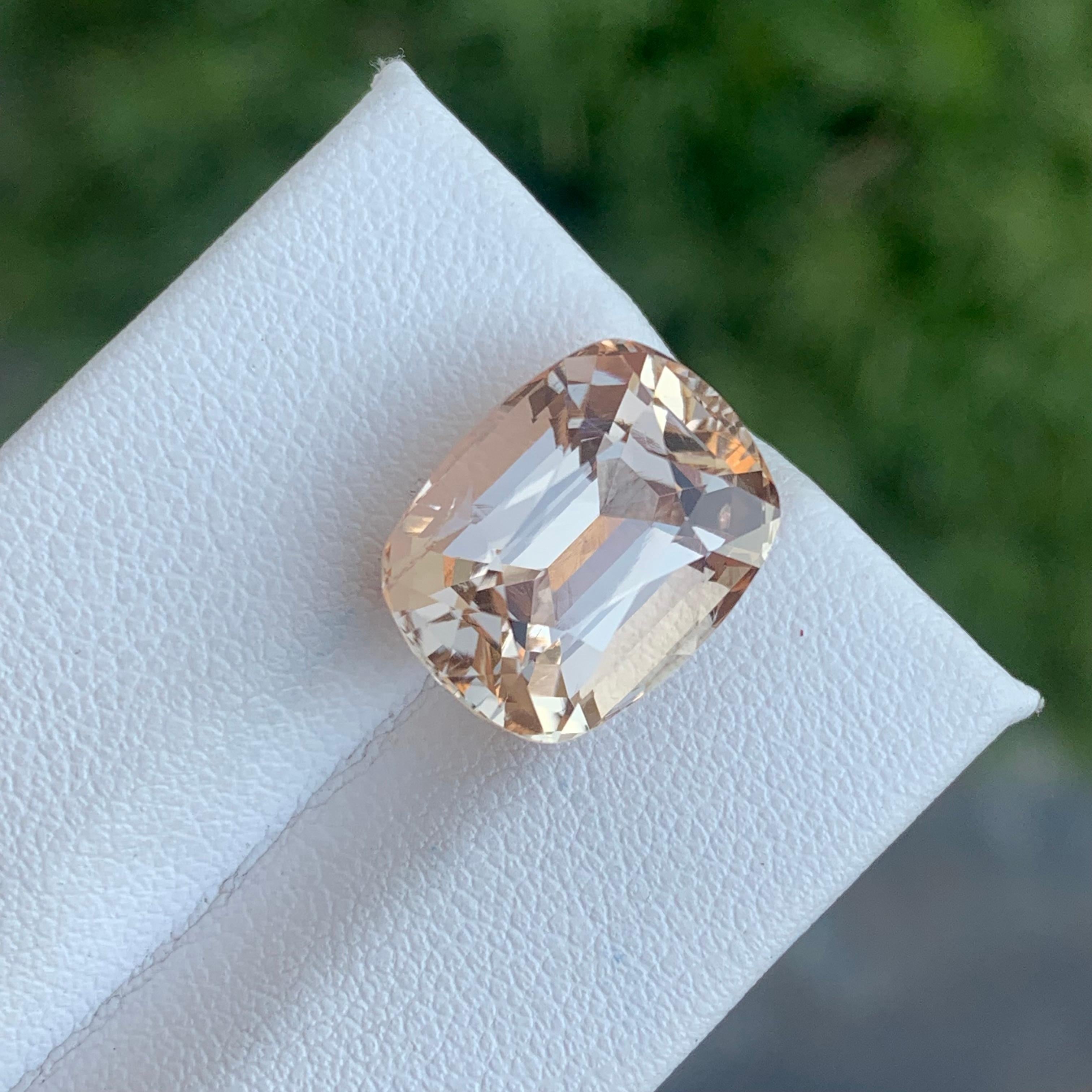 Faceted Imperial Topaz 
Weight: 12.40 Carats
Dimension: 14.3x11.2x9.2 Mm
Origin: Katlang Pakistan 
Shape: Cushion
Color; Peach Imperial 
Treatment: Non
Certificate: On Demand 
Imperial Topaz encourages healthy boundaries and helps us be attracted to