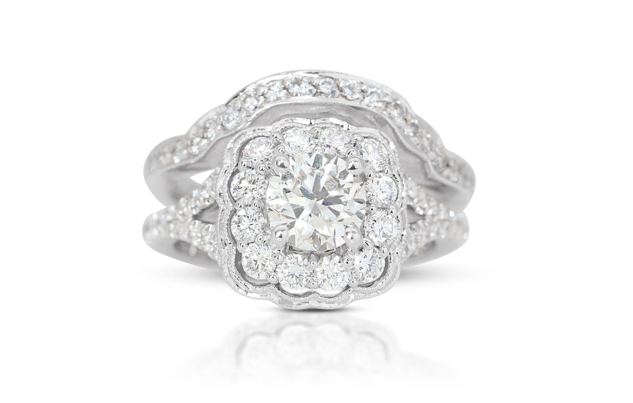 This luxurious ring, crafted in 14K white gold, is adorned with a collection of meticulously selected diamonds. The centerpiece is a round brilliant natural diamond weighing 0.82 carats, characterized by a J color grade that provides a warm tone and