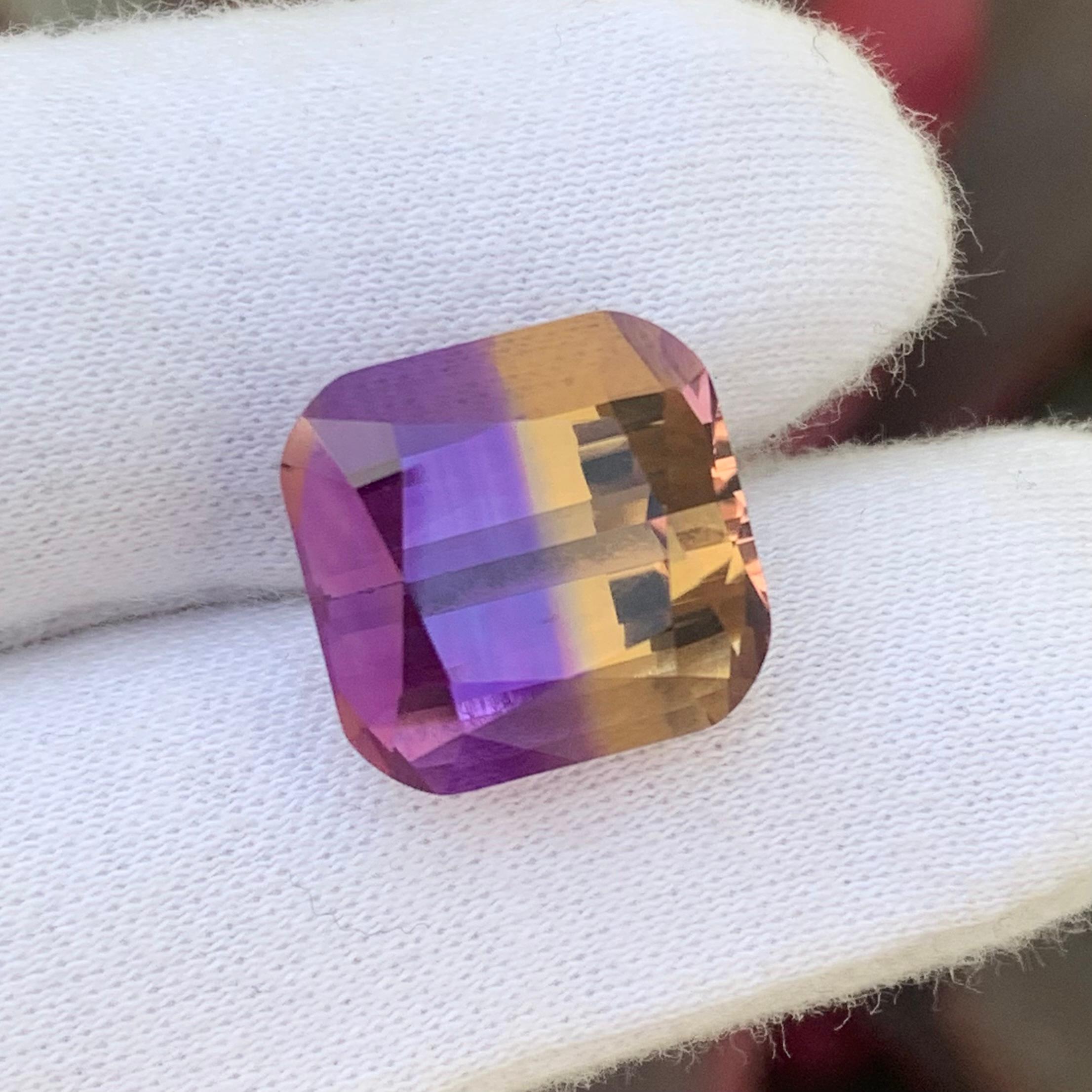 Faceted Ametrine 
Weight: 14.25 Carats
Dimension: 14.4x14x10.3 Mm
Origin: Bolivia
Sjape: Cushion 
Color: Purple & Yellow
Clarity: Loupe Clean
Certificate: On Demand
For those born in the month of February, you've been graced with amethyst as your