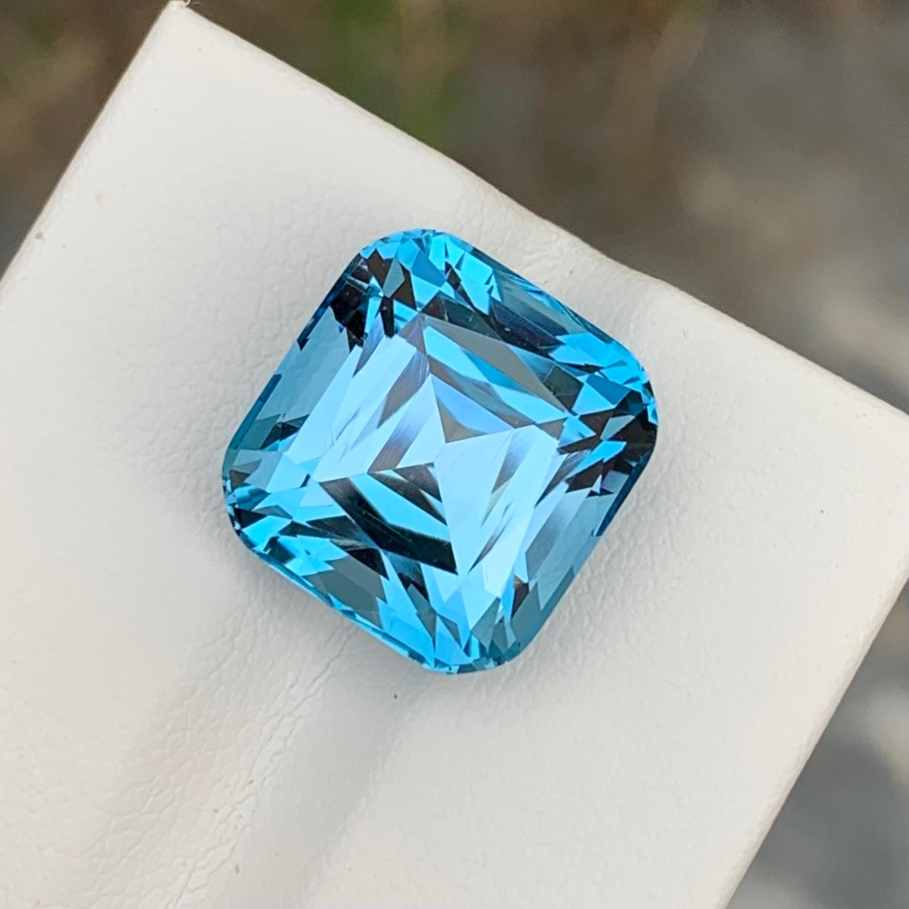 Loose Blue Topaz
Weight: 14.70 Carats 
Dimensions: 13.4x12.7x9.9 Mm
Origin: Brazil
Shape: Cushion
Color: Blue
Treatment: Non
Certificate: On Demand 
Benefits Of Wearing Blue Topaz Stone:
It helps to improve communication and self-expression.
It