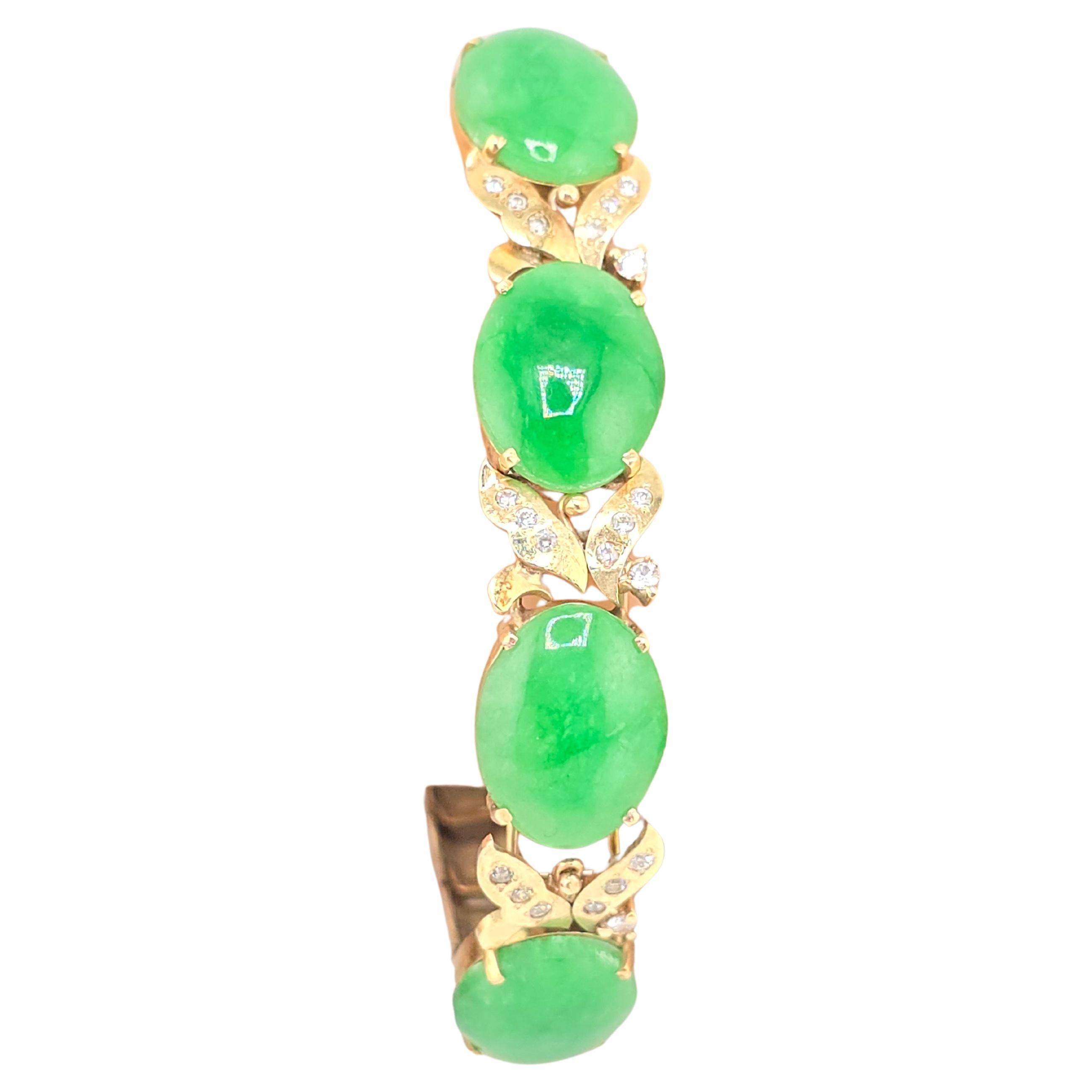 This is a gorgeous, 14 karat yellow gold diamond and green jadeite bracelet. The jades color is extremely vibrant like a forest green. Each stone is easily over 3 carats. There are many diamonds in each section next to the jade possibly 1/4 carat
