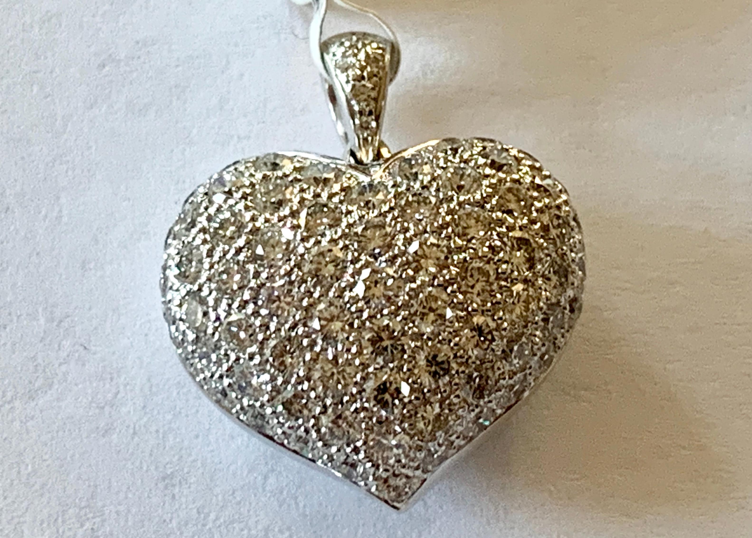 This gorgeous Diamond Heart Pendant in 18 K white Gold Features 75 brilliant cut Diamonds of 1.80 ct, G, vs in pave Setting Size of Heart = 18 mm Wide x 21 mm Long