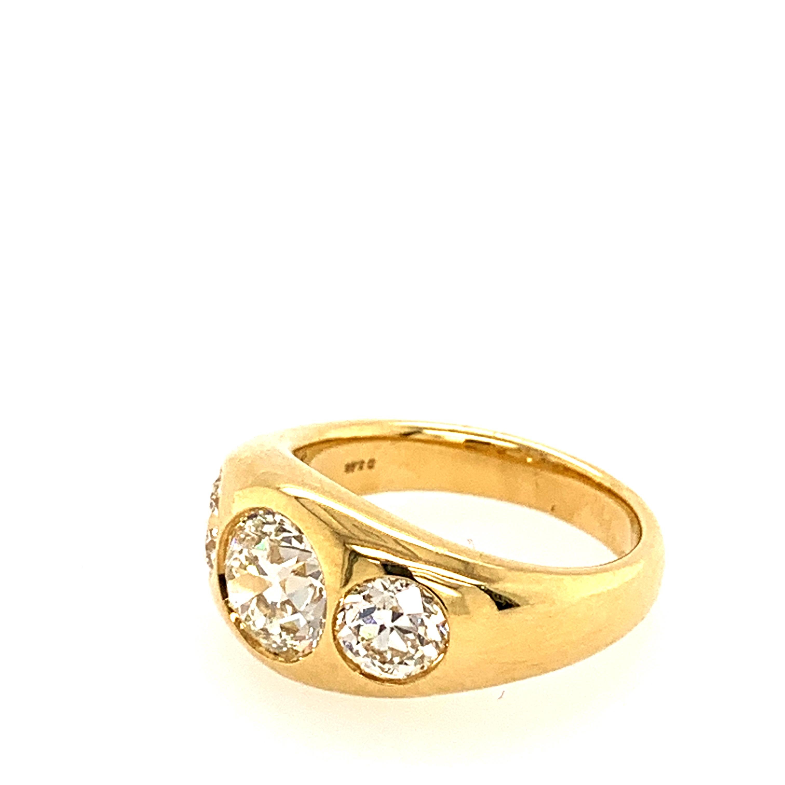 18 Karat Yellow Gold with center round diamond weighing 1.63 Carats and 2 round diamonds on the side weighing a total 1.24 carats.