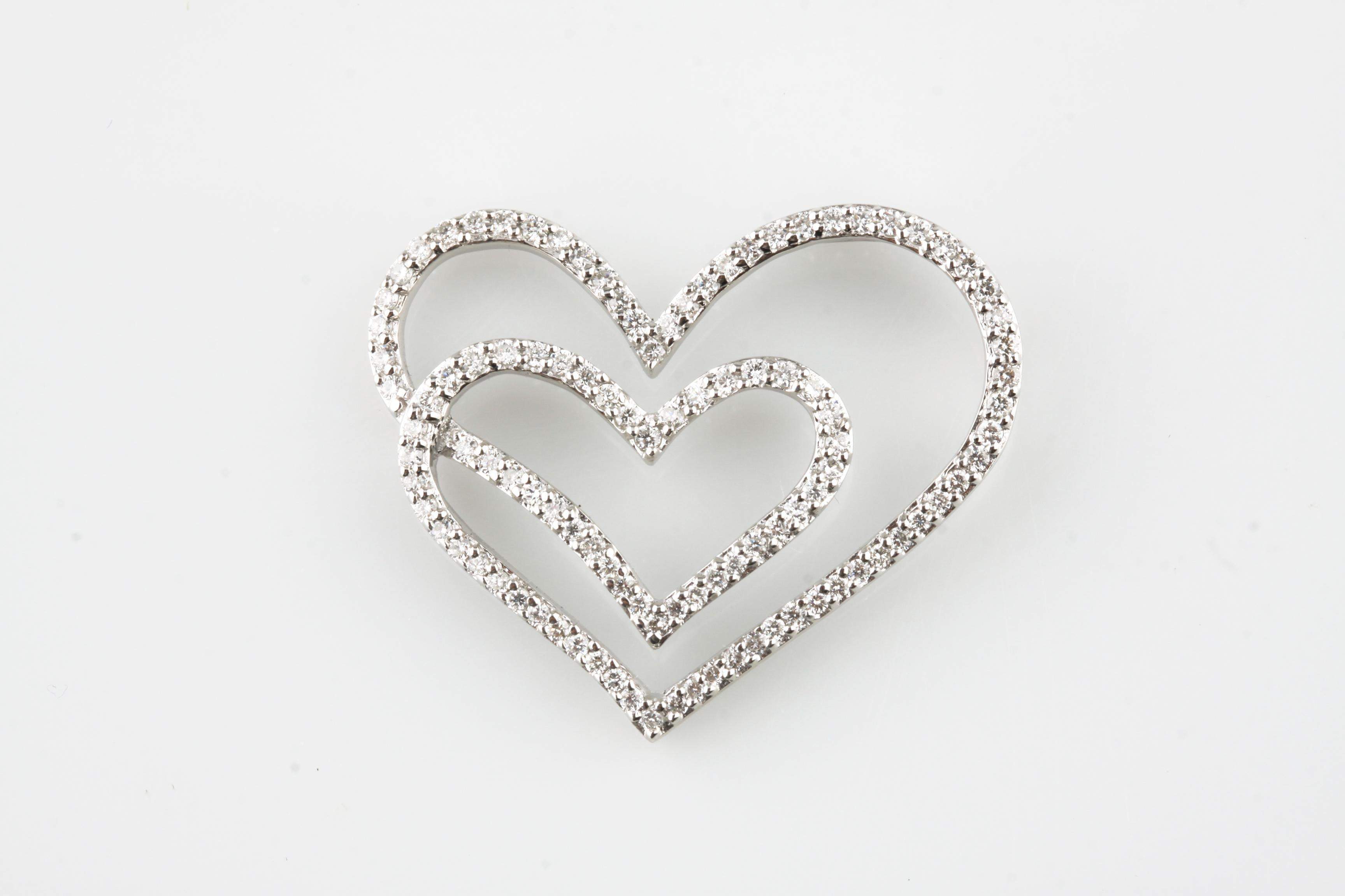 Beautiful Double Heart Pendant
Features Single Pave-Set Row of Round Diamonds in 18k White Gold Outline
Total Diamond Weight = Appx 1 carat
Average Color = G - H
Average Clarity = SI
Width of Pendant = 33 mm
Height of Pendant = 27 mm
Total Mass =