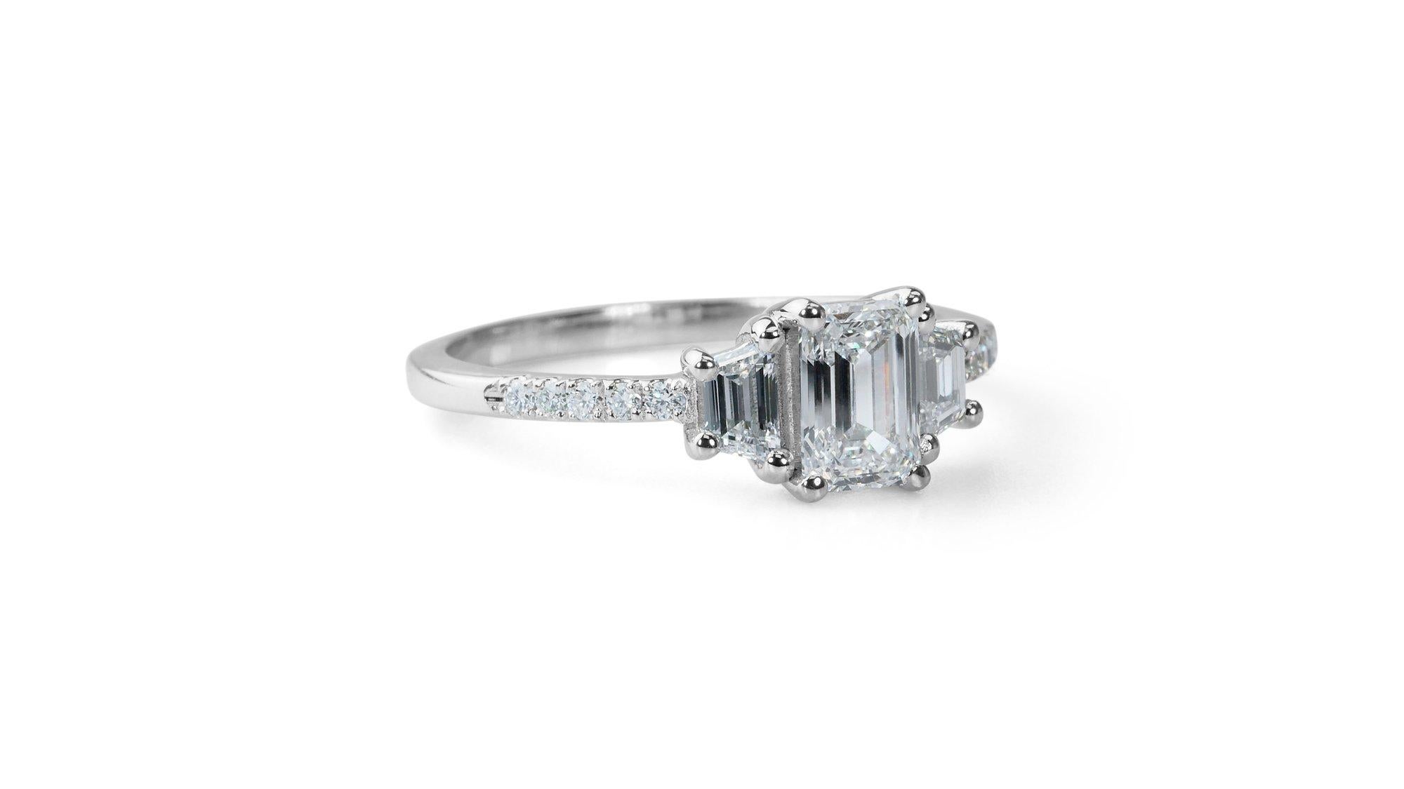 Gorgeous 18k White Gold Natural Diamond 3 Stone Ring w/1.47 ct - GIA Certified 

This exquisite three-stone ring features a stunning emerald-cut at its center with 1.00 carat. And 2 elegant baguette diamonds totaling 0.40 carats together with 10