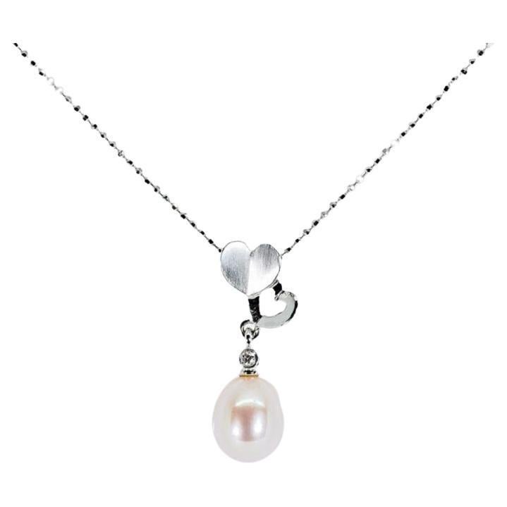 Magnifique pendentif et chane en or blanc 18 carats avec perle naturelle de 0,03 carat et diamants