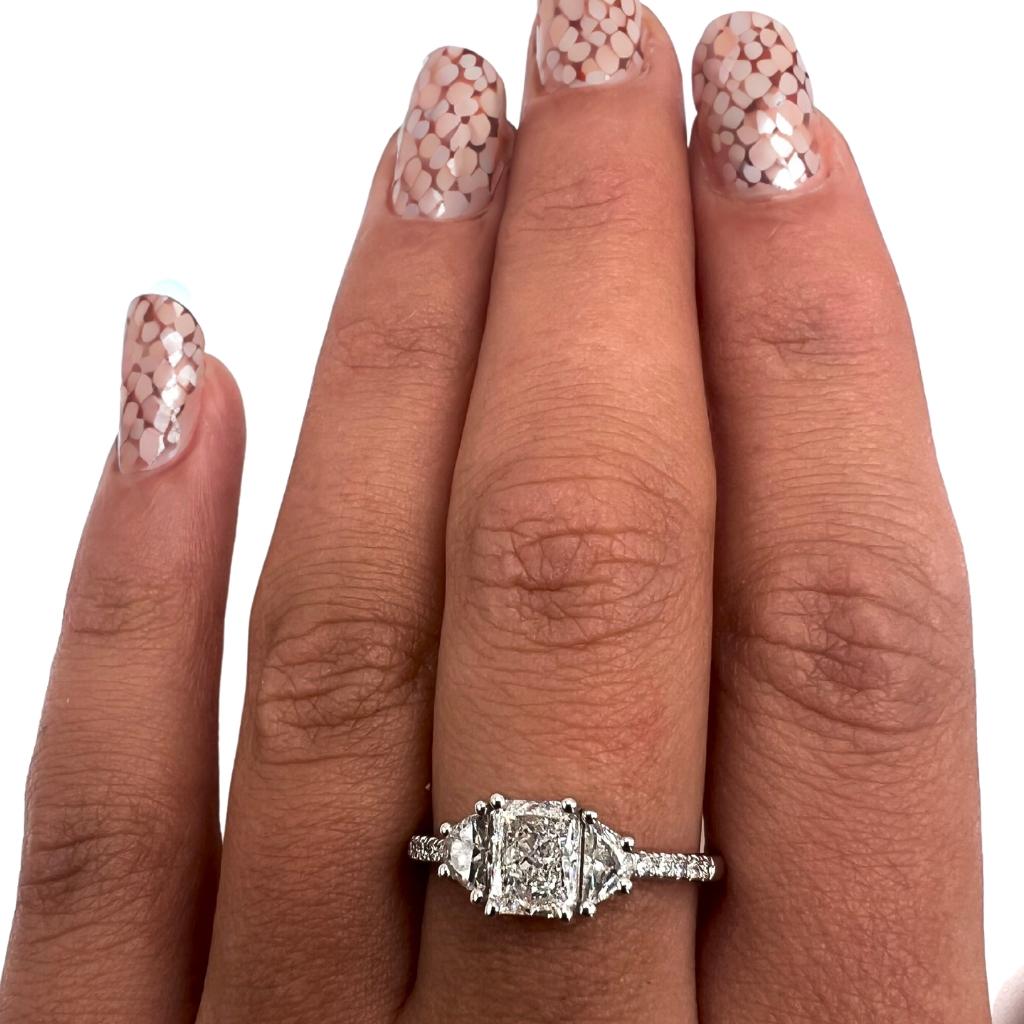 A stunning moon ring with a dazzling 0.92 carat radiant natural diamond. It has 0.31 carat of side diamonds which add more to its elegance. The jewelry is made of 18K White Gold with a high-quality polish. It comes with an IGI certificate and a