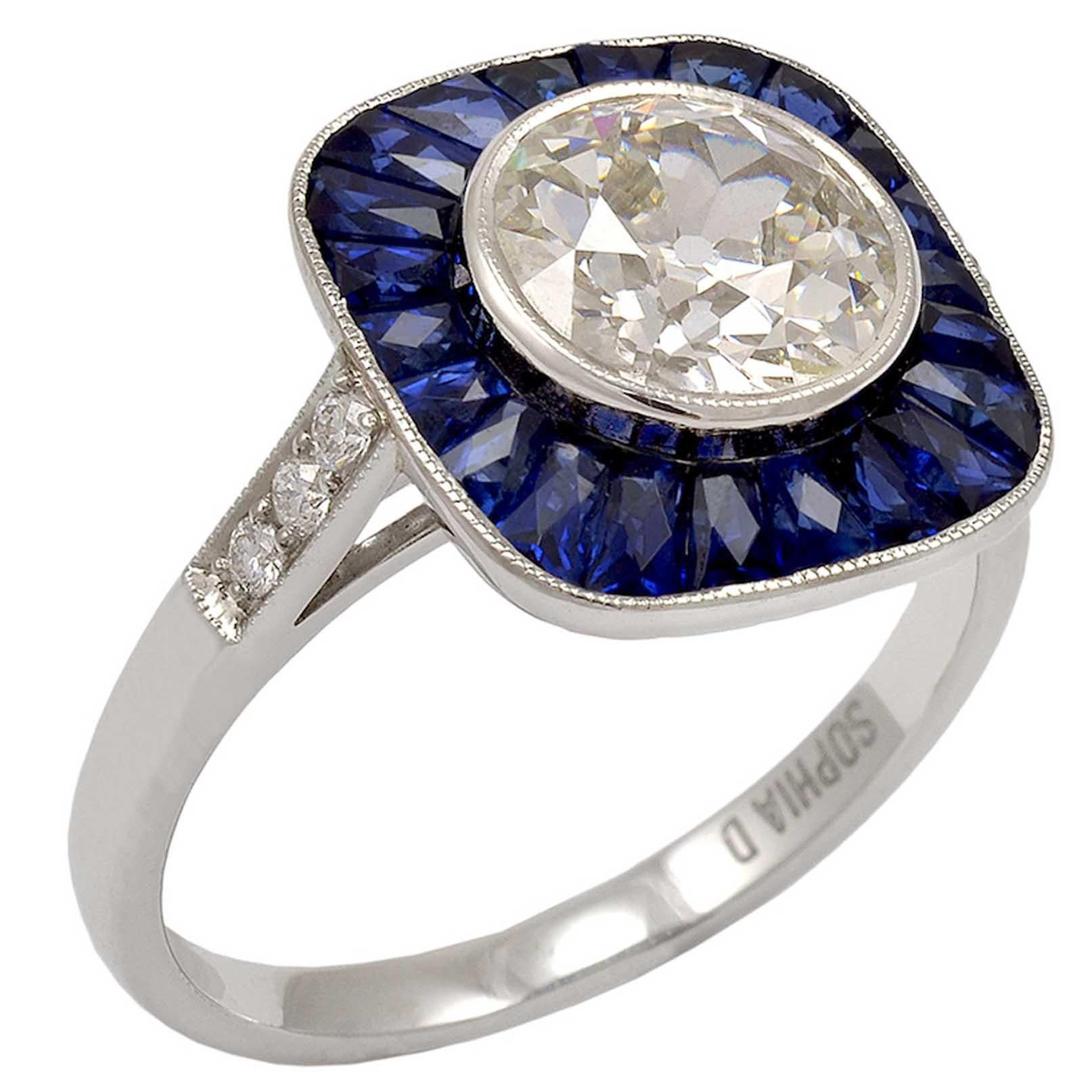 1.92 carat center round diamond surrounded with sapphire weighing 2.65 carats and diamonds weighing 0.23 carats ring.

Sophia D by Joseph Dardashti LTD has been known worldwide for 35 years and are inspired by classic Art Deco design that merges