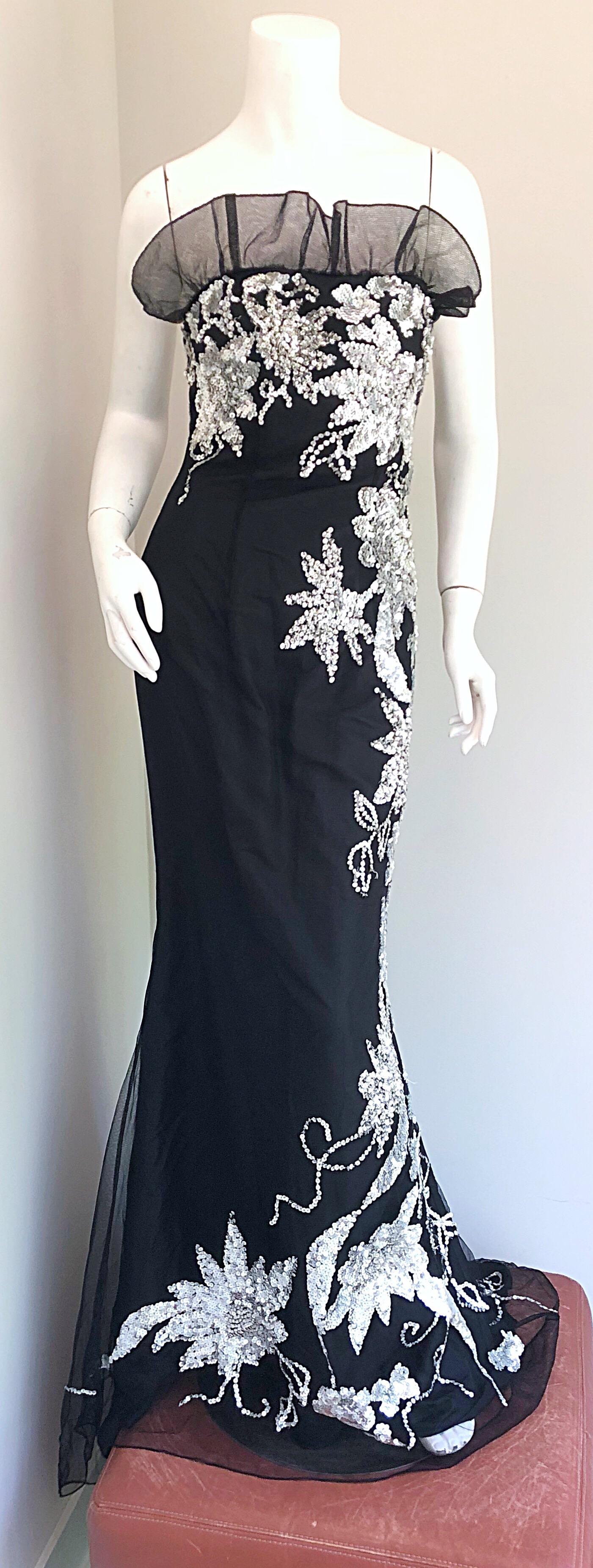Gorgeous early 1990s black and silver tulle and sequined full length strapless evening dress! Features black taffeta with a tulle overlay. Thousands of hand-sewn silver sequins throughout. Ruffled neckline above the bust. Dramatic train in the back