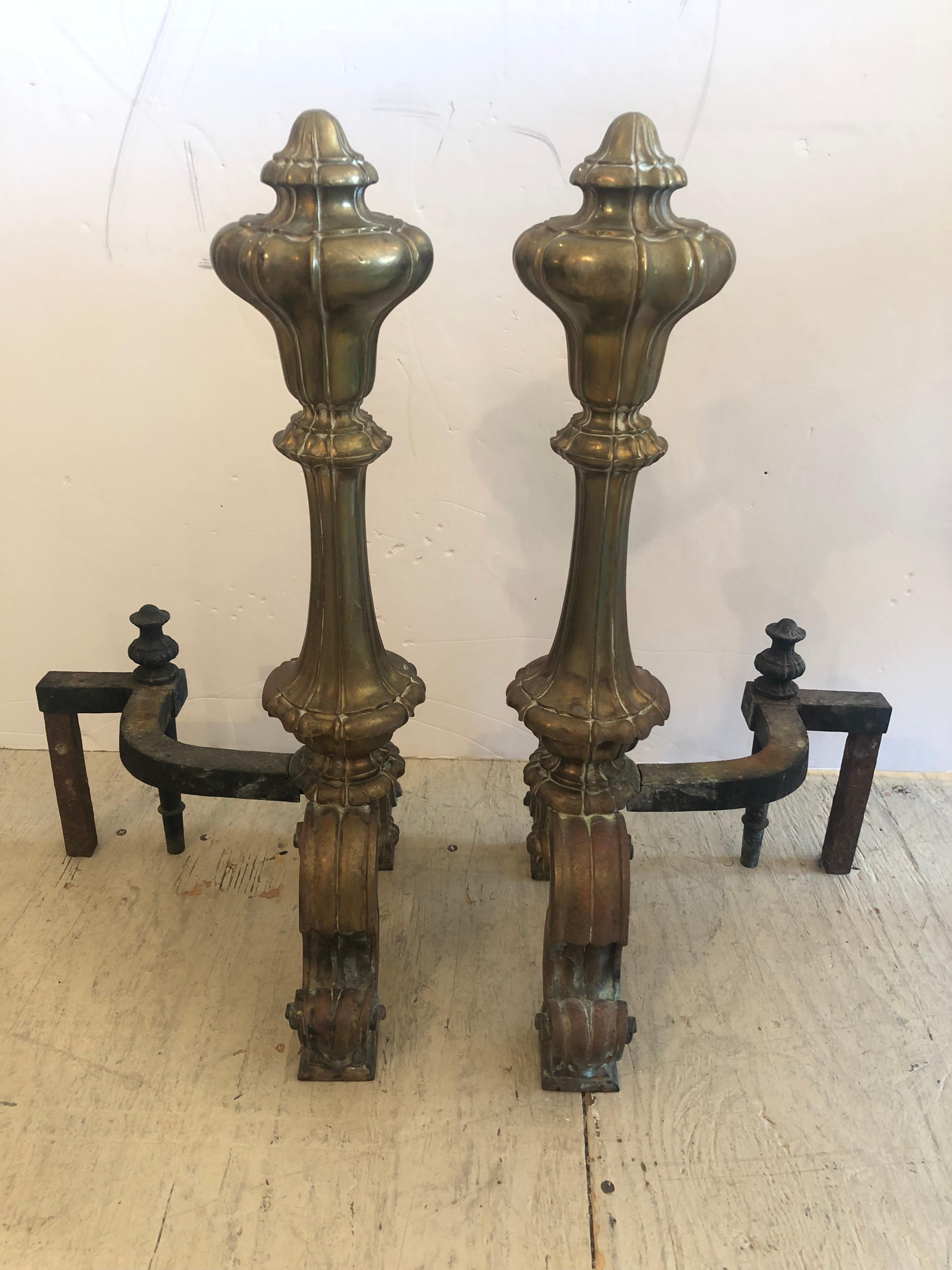 Elegant cast bronze andiron chenets having beautiful detailing and grand shapely finials.