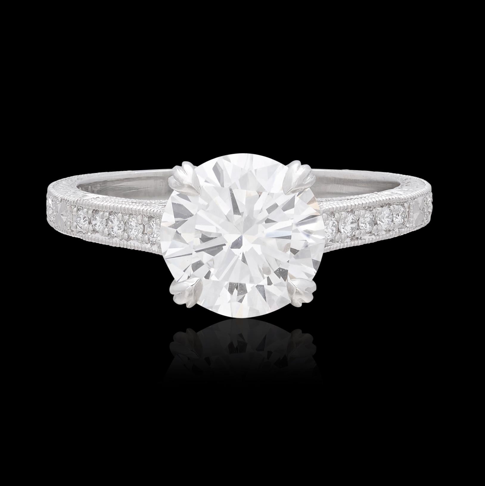 A more stunning diamond engagement ring, you'd be hard pressed to find. This platinum beauty centers around a 2.00 carat round brilliant cut diamond that is about as gorgeous as diamonds get. Graded by the Gemological Institute of America as G color