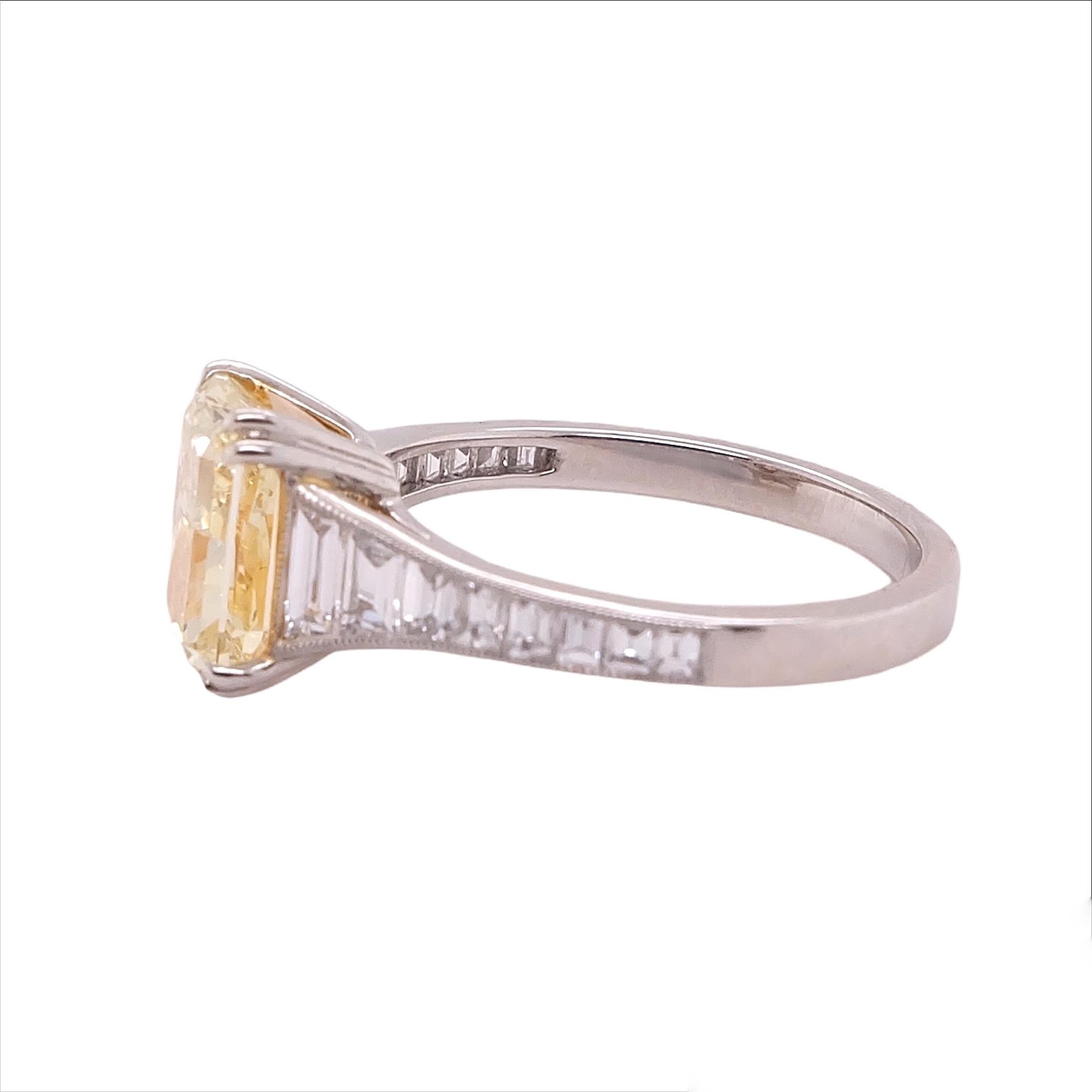 Gorgeous platinum ring by Sophia D. that features a GIA certified fancy light yellow diamond center stone that weighs 2.50 carat with a color and clarity of Y-Z, VVS1 and accentuated with small diamond stones that weigh 0.63 carat. 

Sophia D by