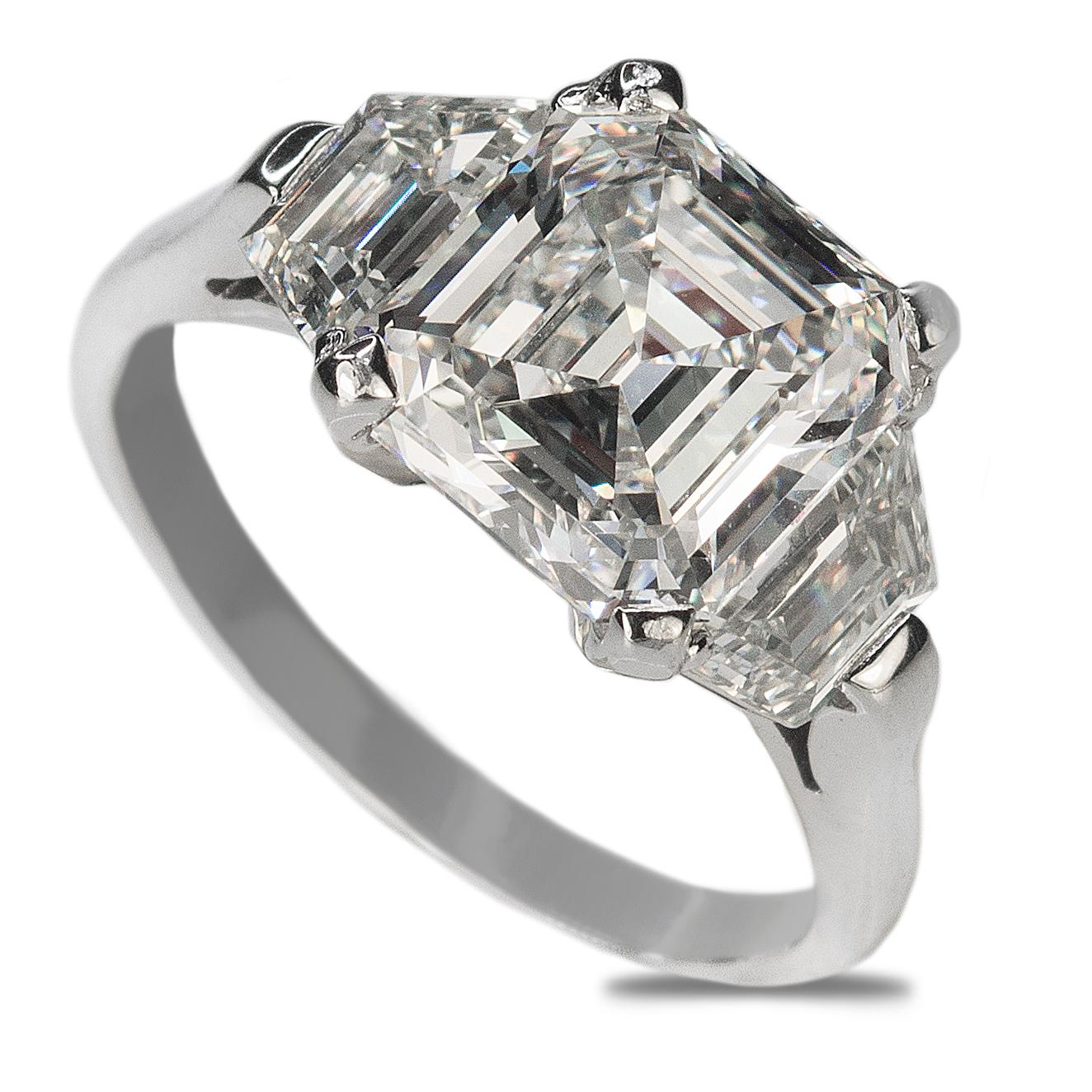 Platinum Ring with GIA certified 3.05 carat H color VS1 clarity Asscher Cut diamond and two step cut trapazoid diamonds weihing 1.27 carats.