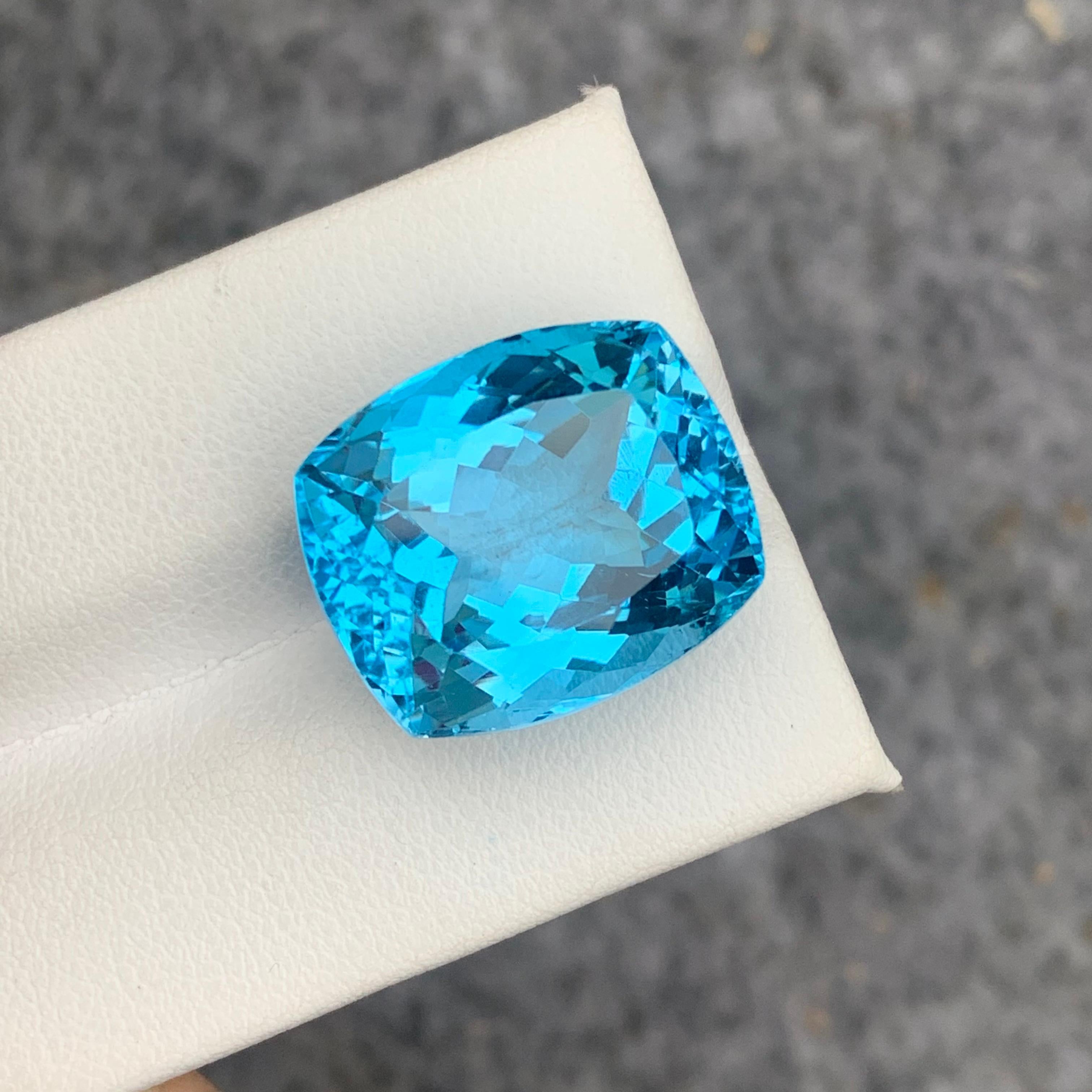 Faceted Sky Blue Topaz 
Weight : 31.10 Carats
Dimensions : 18.9x16x11.6 Mm
Origin : Brazil
Clarity : Eye Clean
Shape: Cushion
Cut/Facet: Cushion 
Color: Blue
Certificate: On Demand
Blue Topaz Metaphysical Properties
Blue topaz, in particular, is