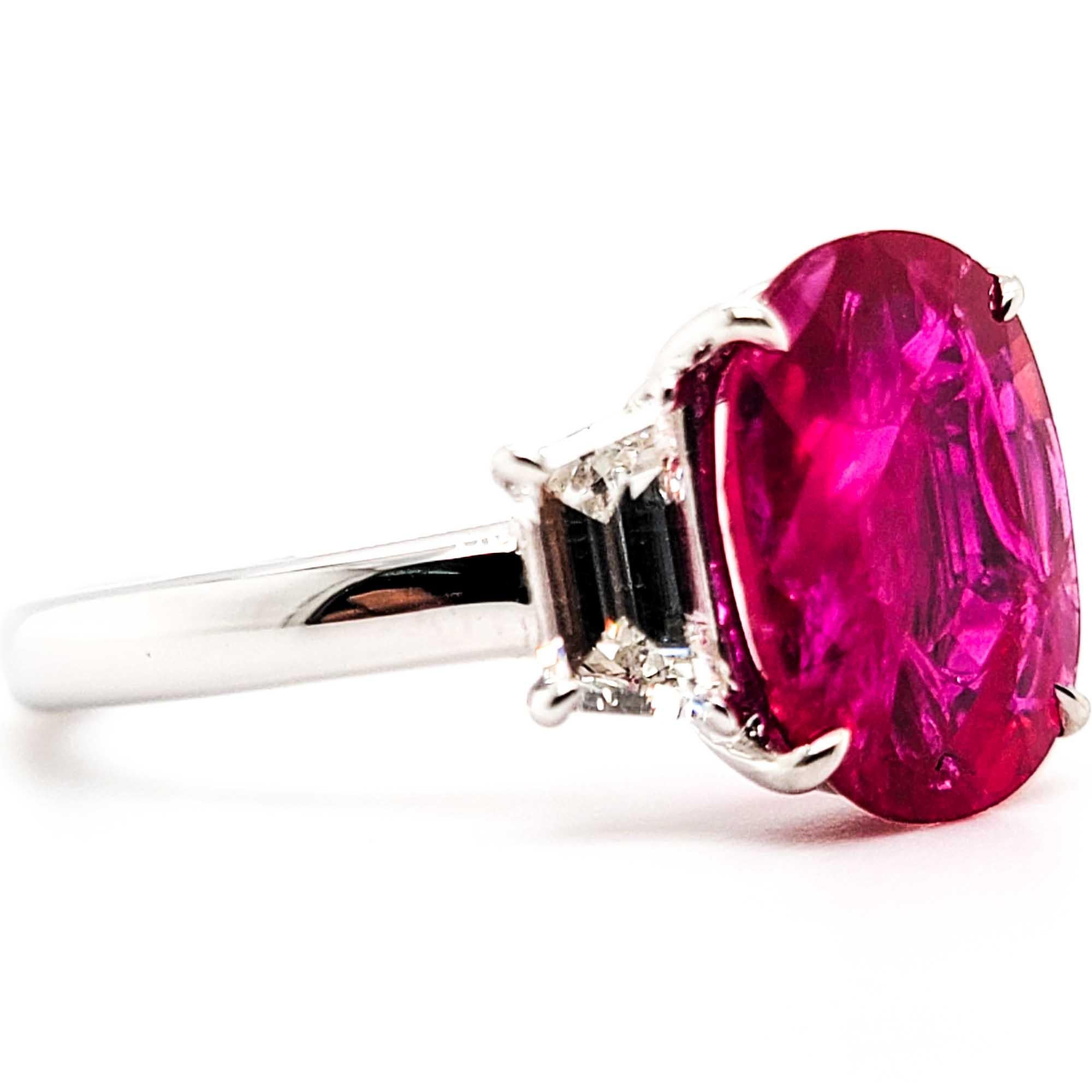 3.39 carat ruby ring with trapezoid diamonds on the side weighing 0.72 carats.