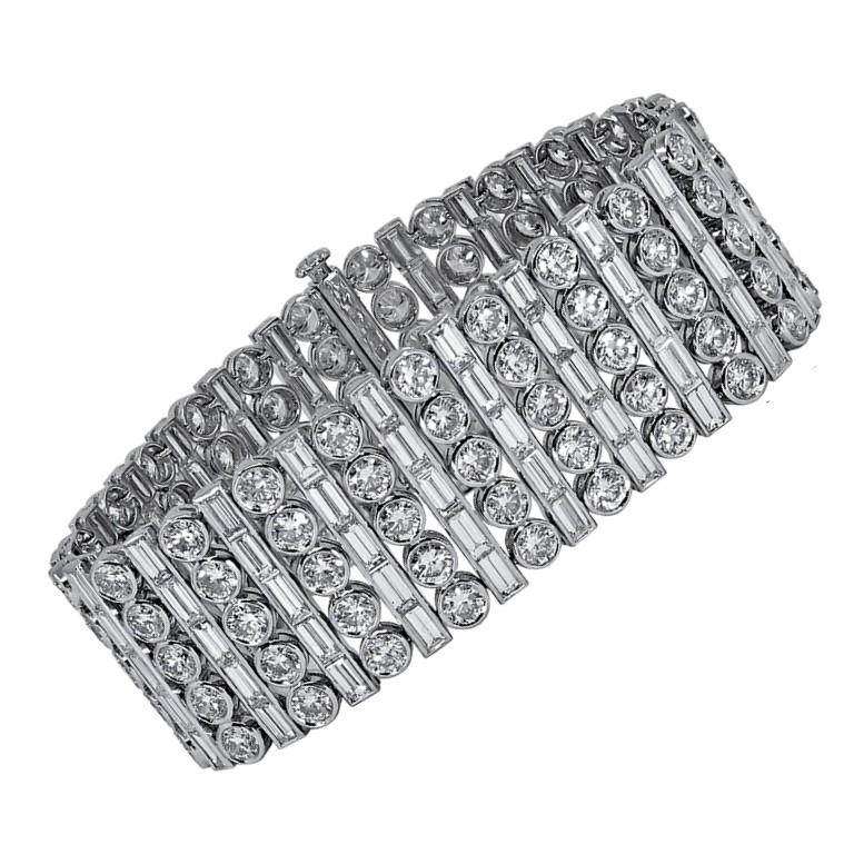 This bracelet is designed with 115 pieces of baguette cut diamonds with the total carat weight of 18.65 together with 115 pieces of round diamonds with the total carat weight of 21.59. 

Sophia D by Joseph Dardashti LTD has been known worldwide for