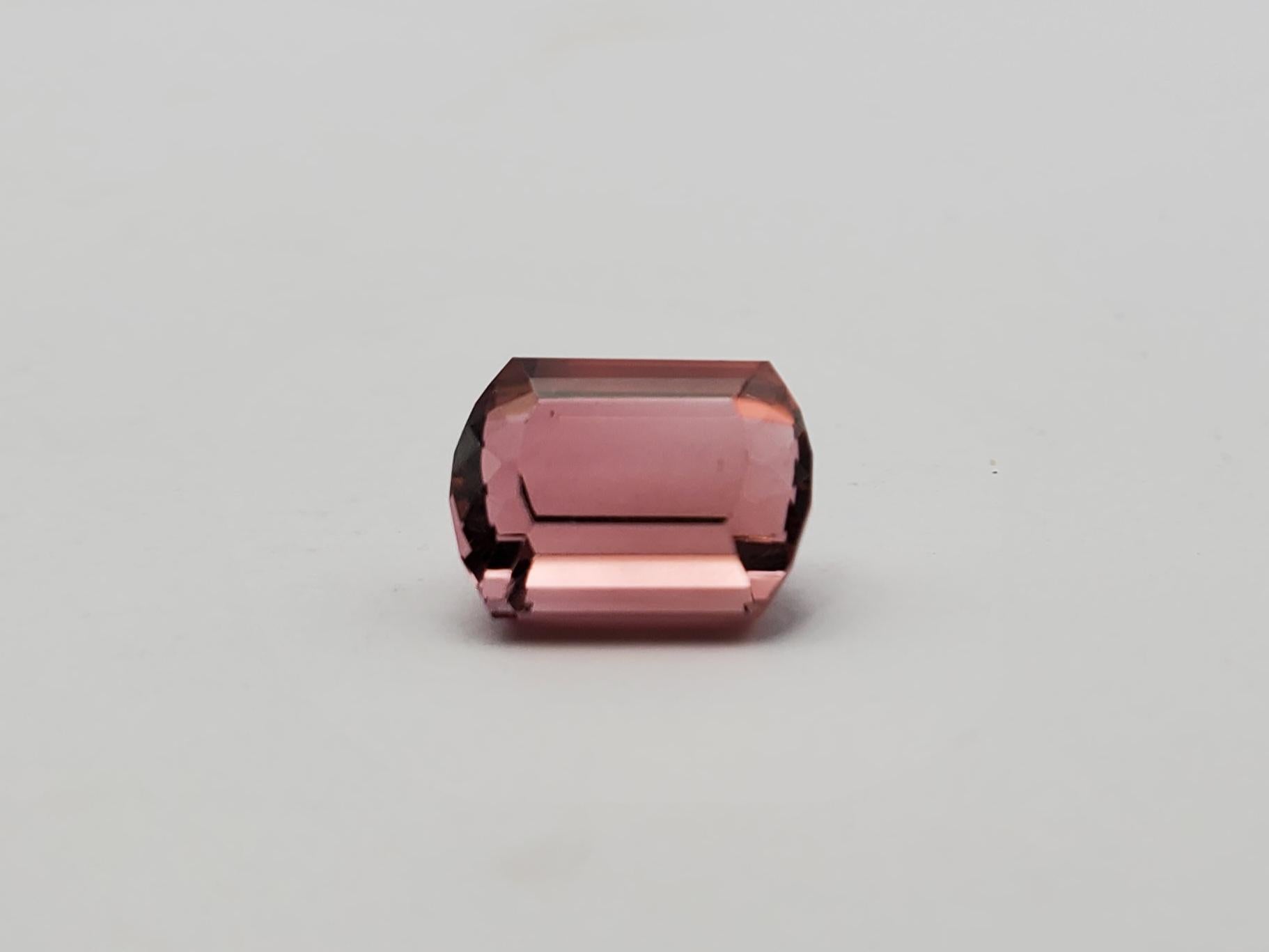 Crafted from the earth's natural treasures, this stunning 6.45ct pink tourmaline is a testament to beauty and craftsmanship. The gem exhibits a barrel cut shape, giving it an unusual silhouette that is both eye-catching and enchanting. Measuring an