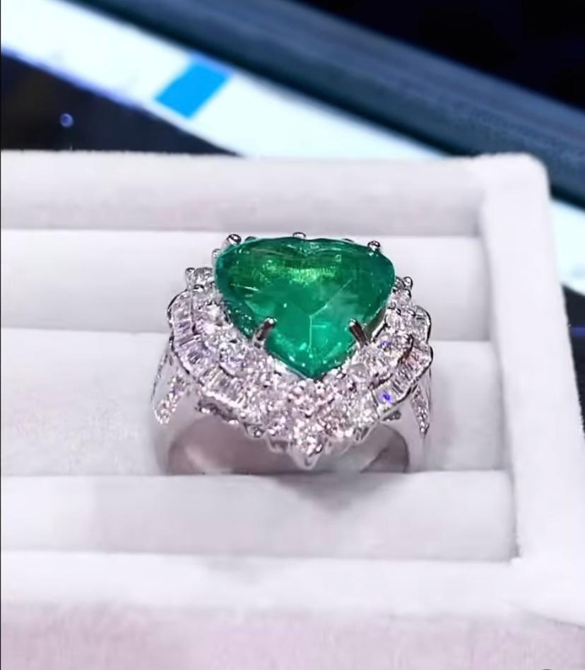 An exceptional and refined design from love collection, a very adorable style , for lover addicted. A very sophisticated style.
Ring come in 18k gold with a heart cut  natural Zambia Emerald  of 6,60 carats , fine grade and quality, and round