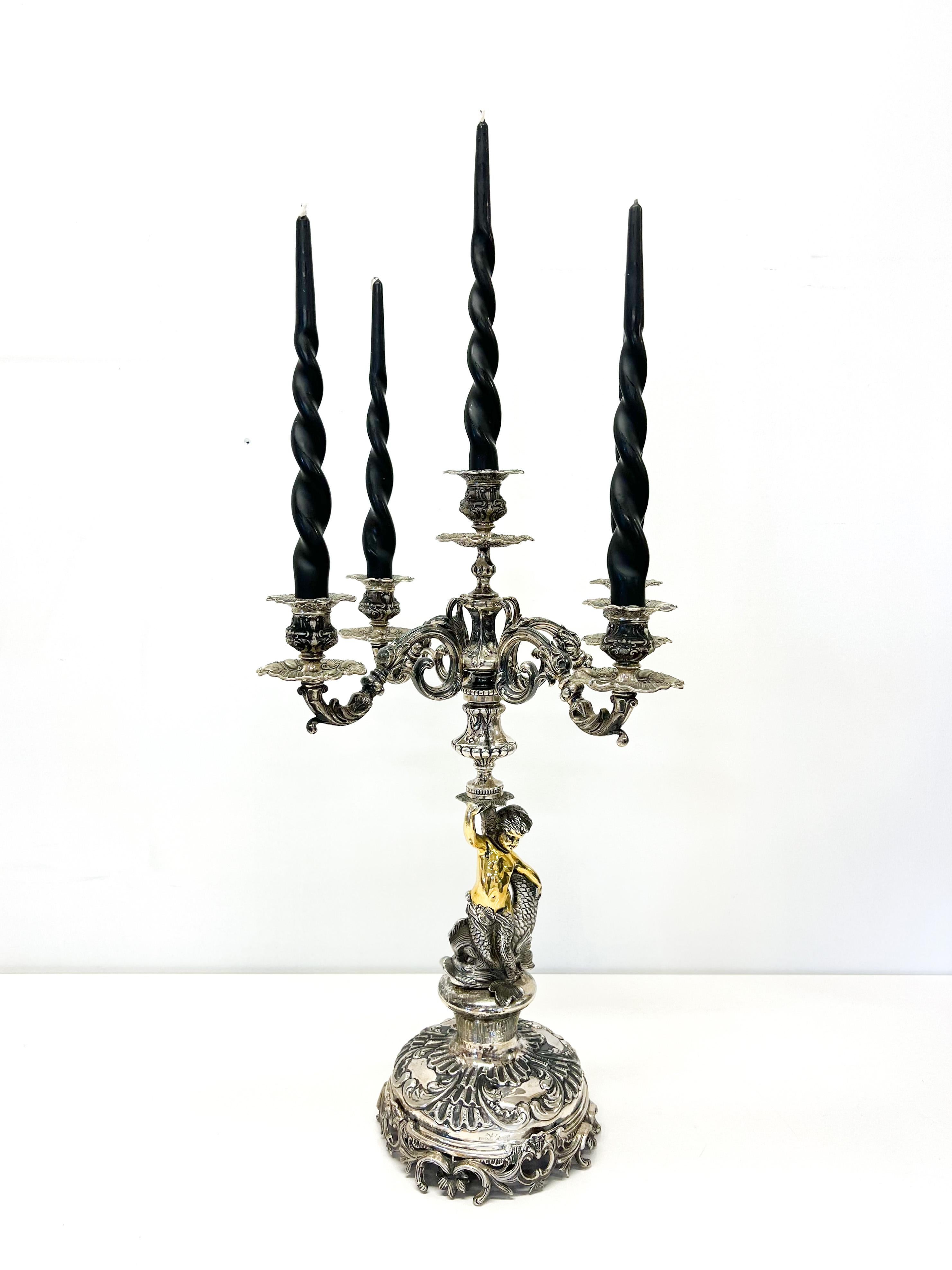 A Five-Branched Candelabrum
The silver candlestick, which rises to a height of more than half a meter and weighs 3.364 kilograms, is supported by a pair of carp and a golden two-tailed Merenmale. The boy character will represent the young Triton,