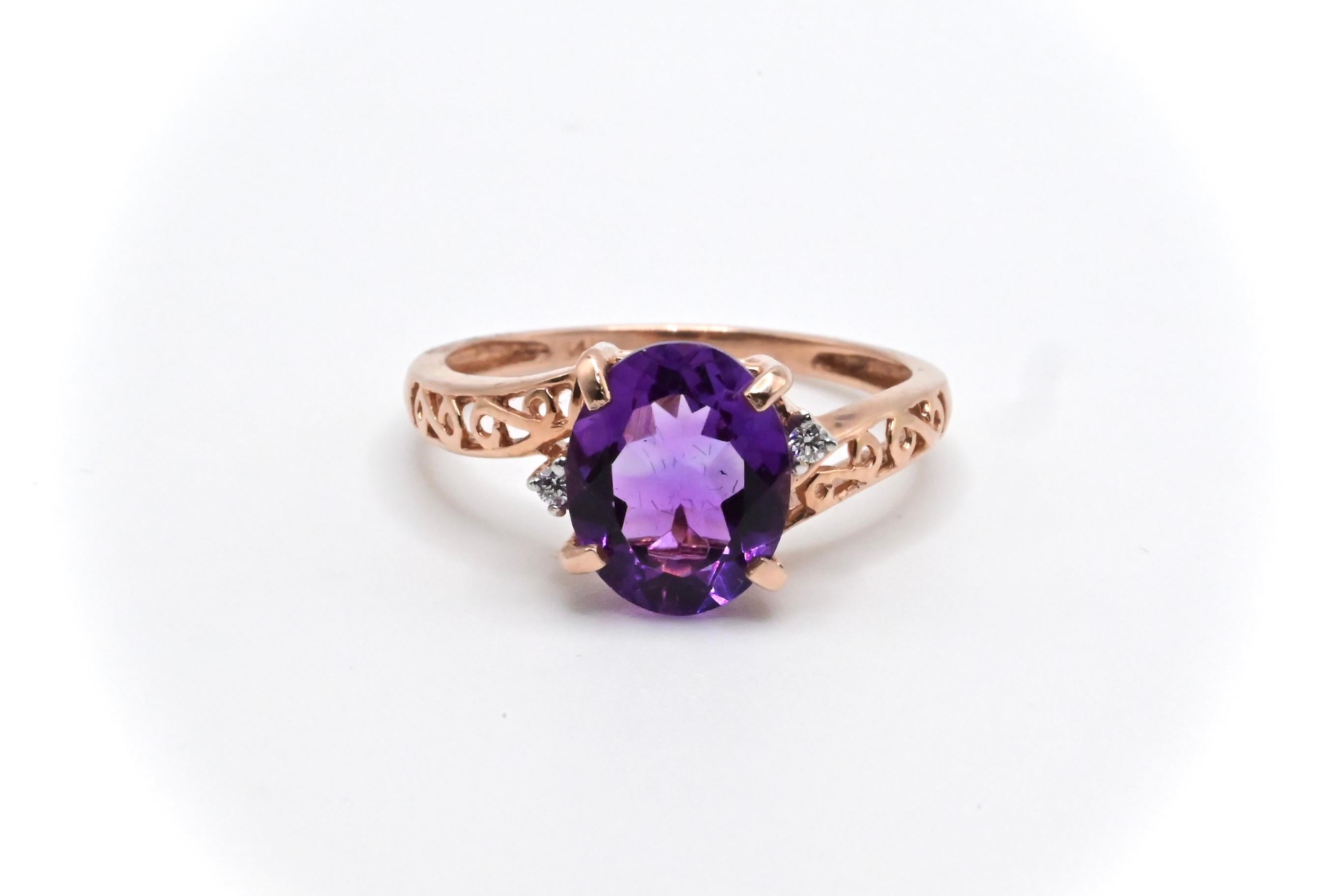 This is an eye catching 14k gold ring that’s made out of a sparkling oval cut purple amethyst, and a  round cut diamond complementing each side of the centerpiece. It’s a size 6 3/4, and weighs about 2 grams. It’s in excellent condition with little