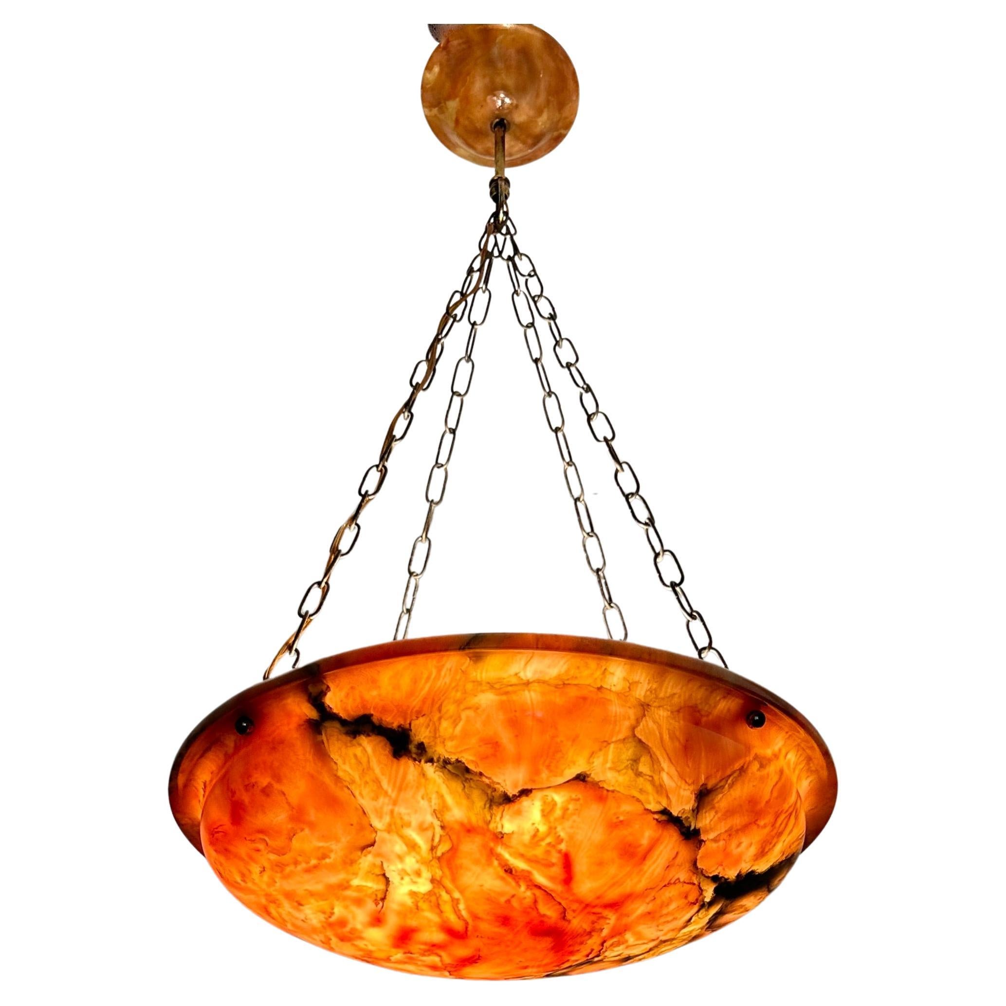 Stunning 4-light alabaster shade with firelight colors when switched on.

This light fixture is another one of our recent great finds and with the stylish chain and matching alabaster canopy it is another great fixture to enjoy and look at. The