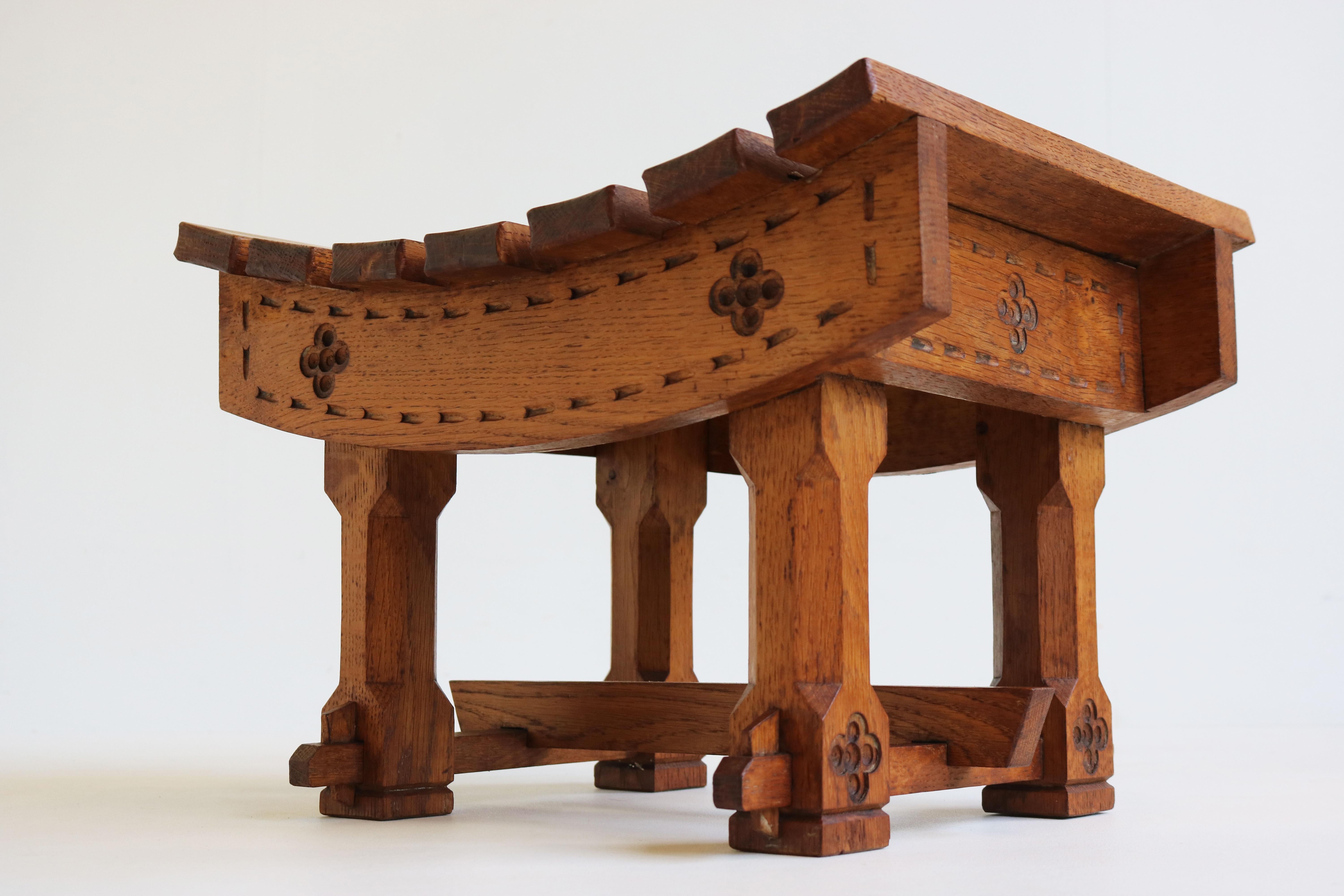 Masterfully crafted Antique Dutch Arts & Crafts footstool / stool made in the 1900s. 
Gorgeous European oak with amazing patina, richly decorated with carvings. 
The seat is fully bent & combined with the wood joints a perfect display of