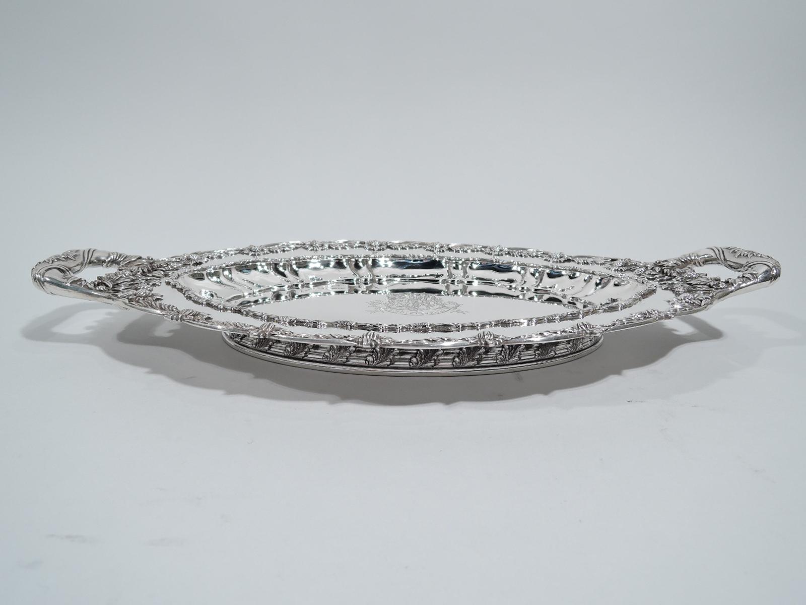 Chrysanthemum sterling silver serving dish. Made by Tiffany & Co. in New York. Ovalish well, curved sides with lobing and applied leaf border, and scalloped rim with the famous chrysanthemum flower heads alternating with leaves. A profusion of