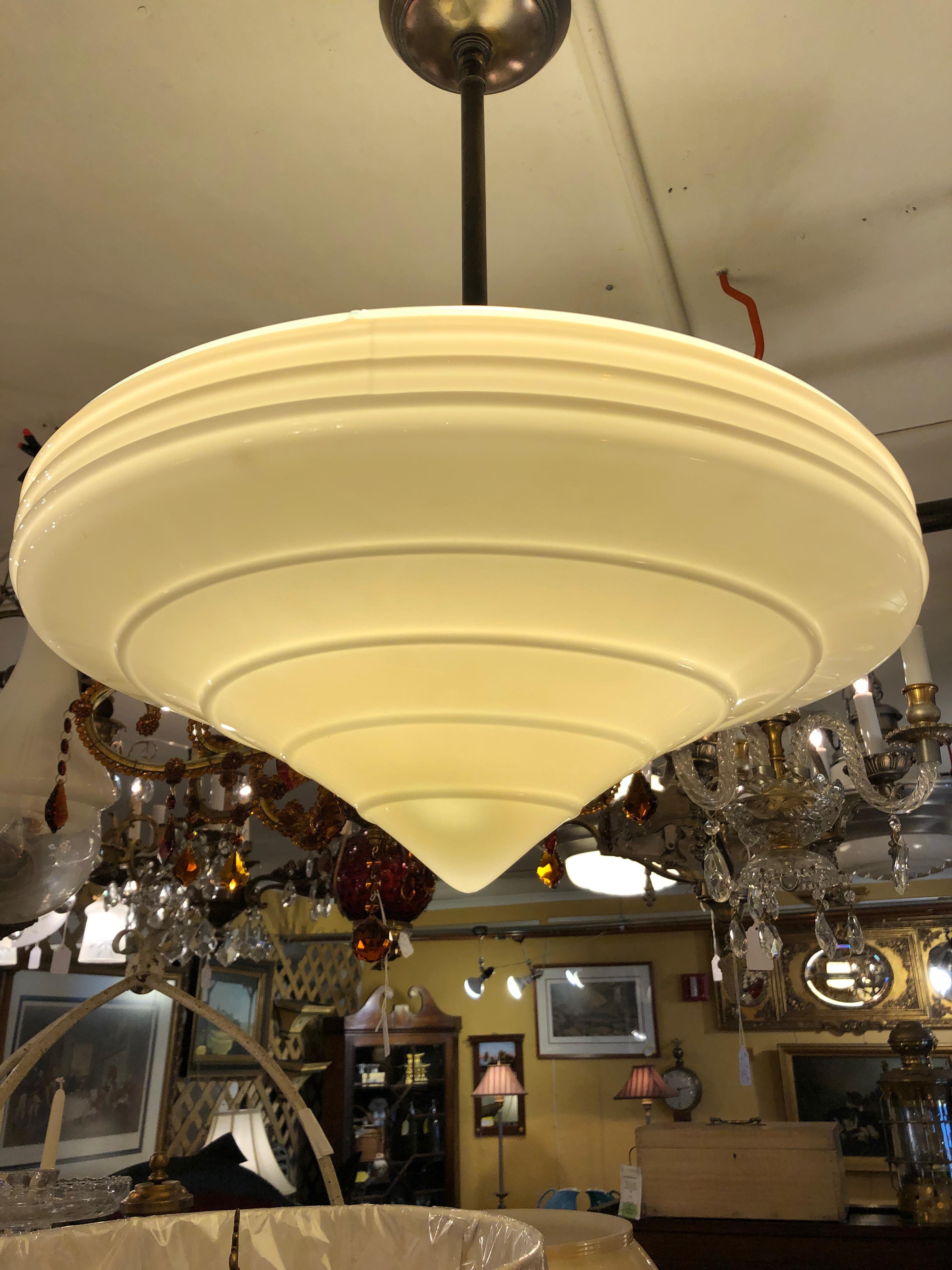 A striking Art Deco pendant light fixture having a gorgeous round pointed milk glass shade.
Note: 4 available.
