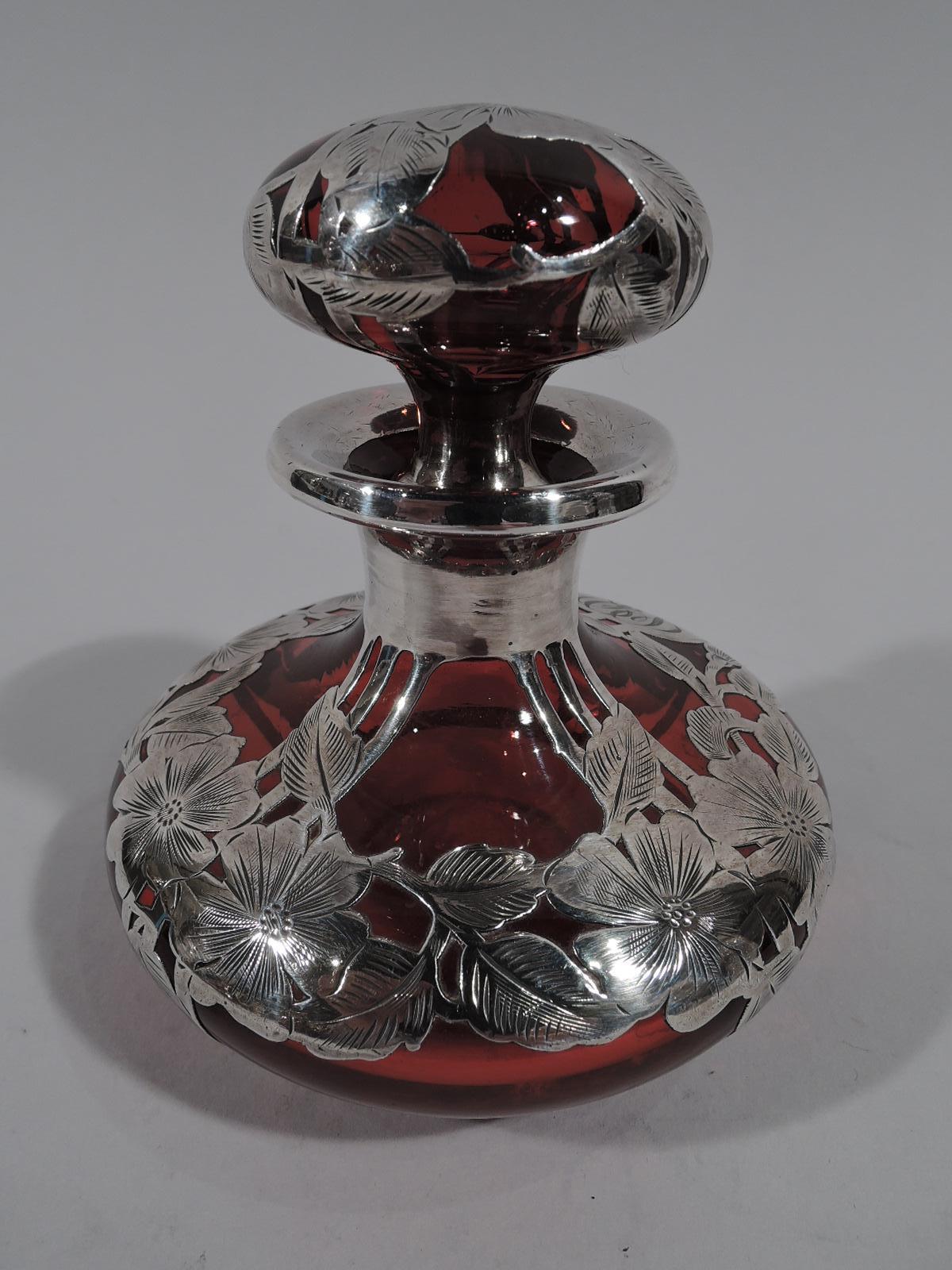 Gorgeous turn-of-the-century Art Nouveau red glass perfume with engraved silver overlay. Made by Alvin in Providence. Bellied bowl with short neck and flattened ball stopper. Overlay in form of garland over pilasters, and circular frame engraved