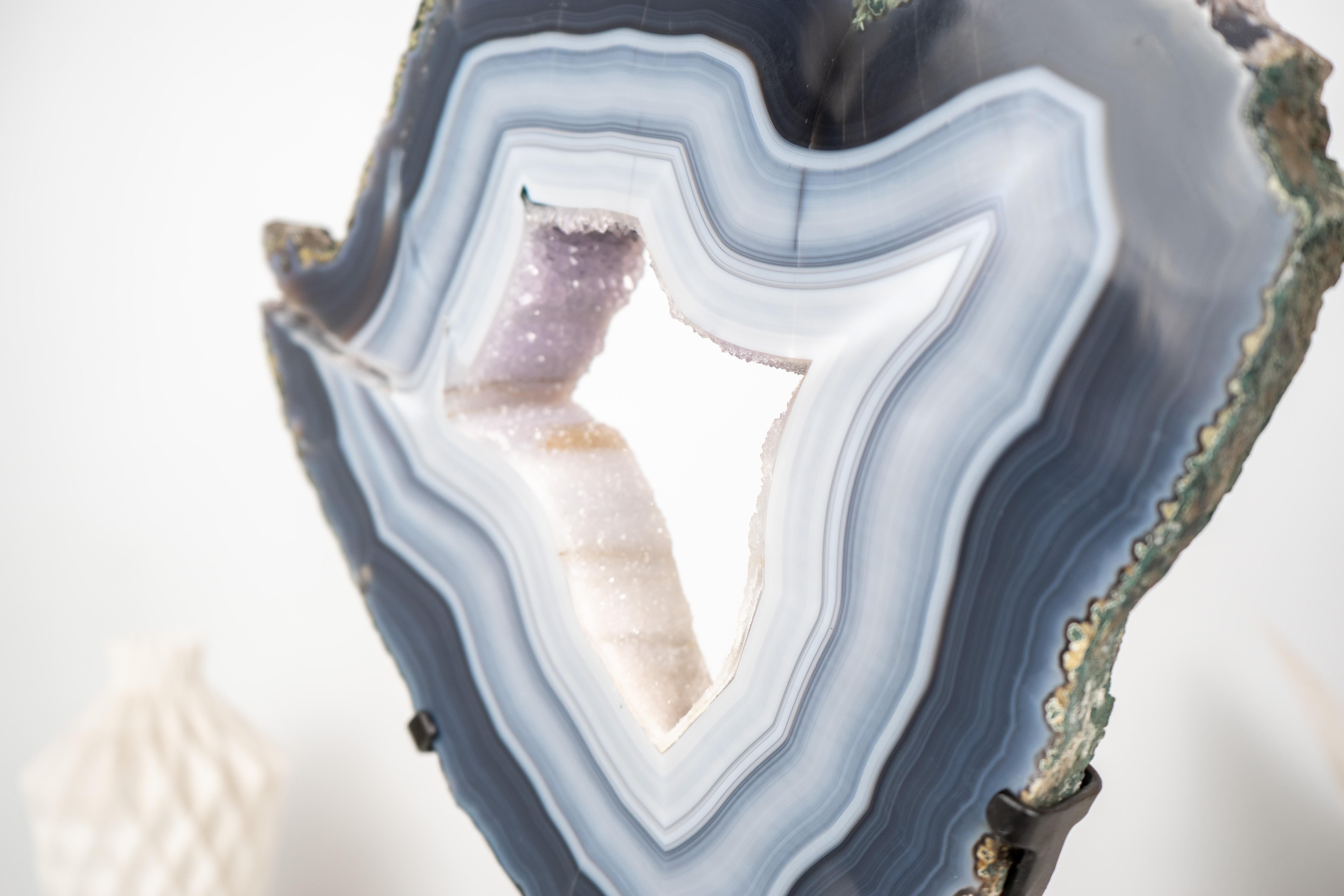 White and Blue Lace Agate Geode Slice with White Galaxy Amethyst Druzy

▫️ Description

A superb agate geode slice with bold white and blue laces, this ethically sourced specimen reveals the hidden beauty of nature once cut. The slice showcases