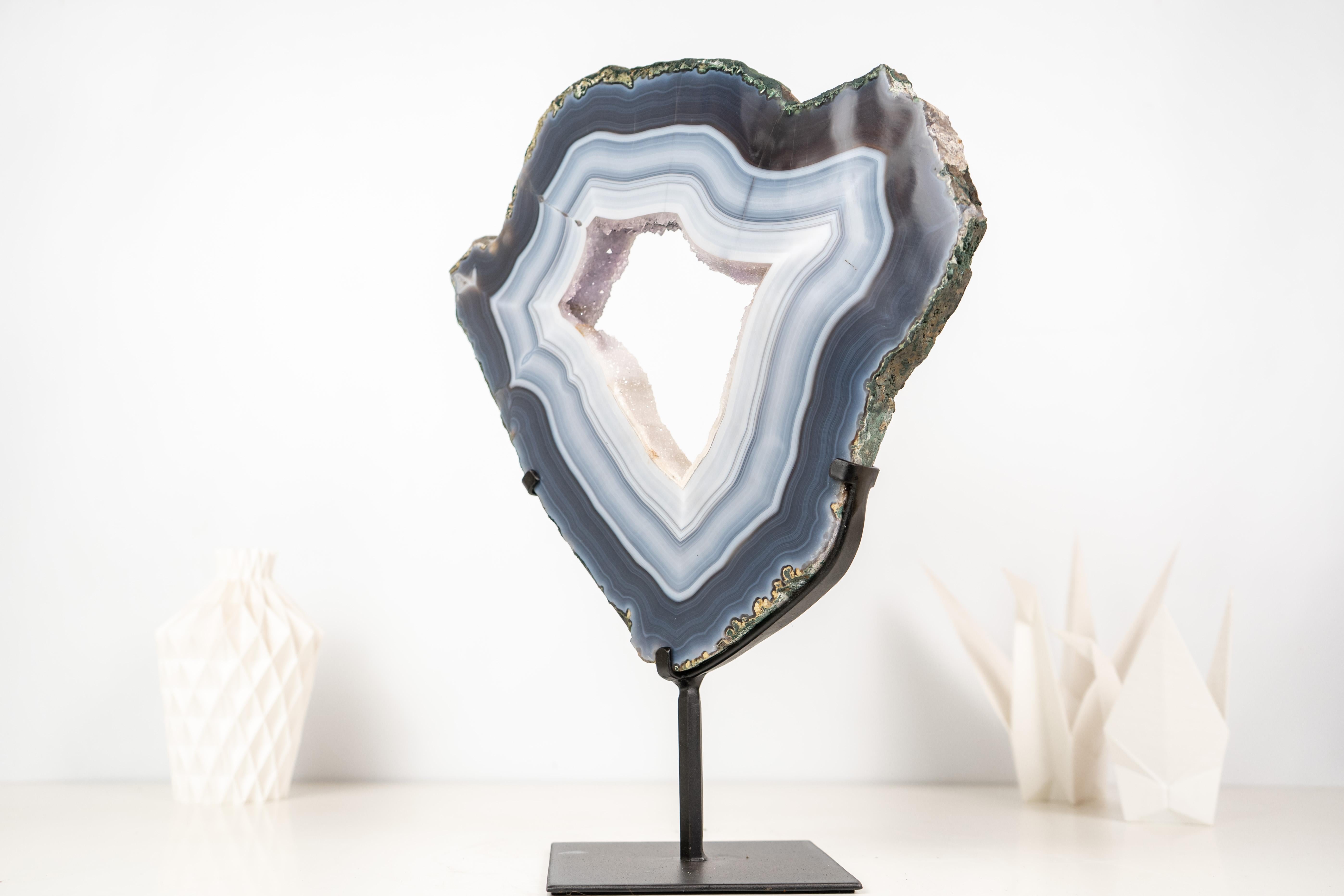 Sculptural White and Blue Lace Agate Geode Slice with White Galaxy Amethyst Druzy

▫️ Description

Naturally sculptural with its curvy lines and bold white and blue laces, this ethically sourced specimen revealed the millions of years of nature