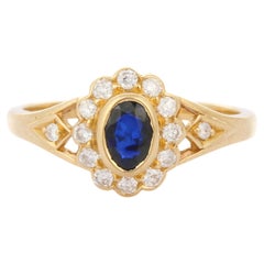 Dainty Blue Sapphire Enclosed with Diamonds Engagement Ring in 18K Yellow Gold