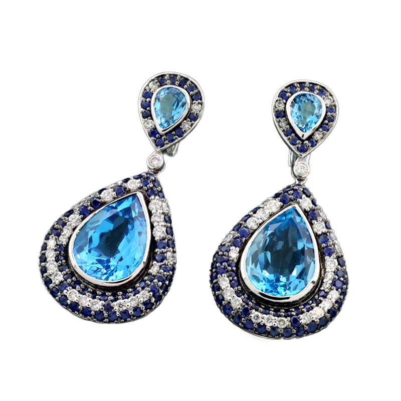 A pair of drop-shaped earrings featuring 4 faceted blue topaz stones totaling approx. 25.10 carats, framed by 58 brilliant-cut diamonds totaling approx. 2.20 carats, color: Wesselton, clarity: SI, and 140 round cut blue sapphires totaling approx.