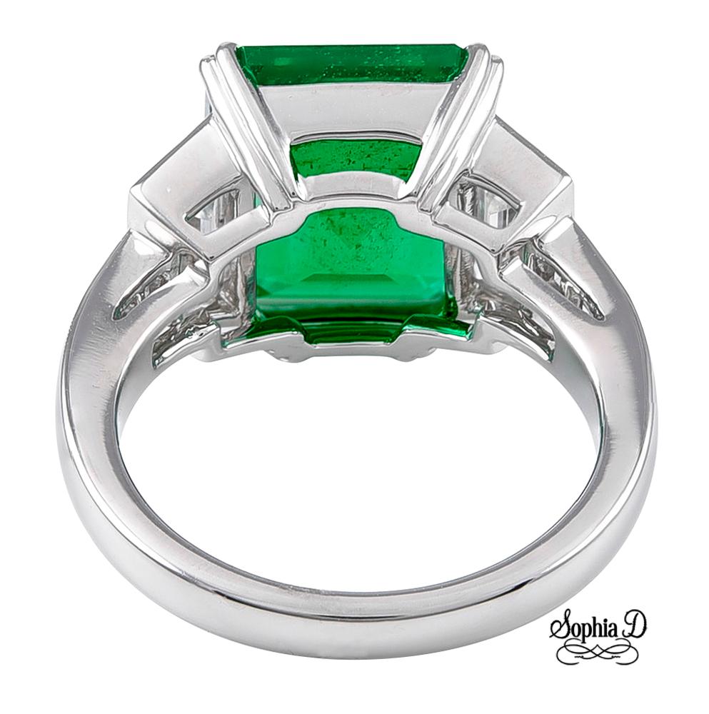 Certified green emerald center stone with a total carat weight of 2.31 with two half moon diamonds on the side weighing 0.63 carats and two baguette diamonds weighing 0.31 carats.