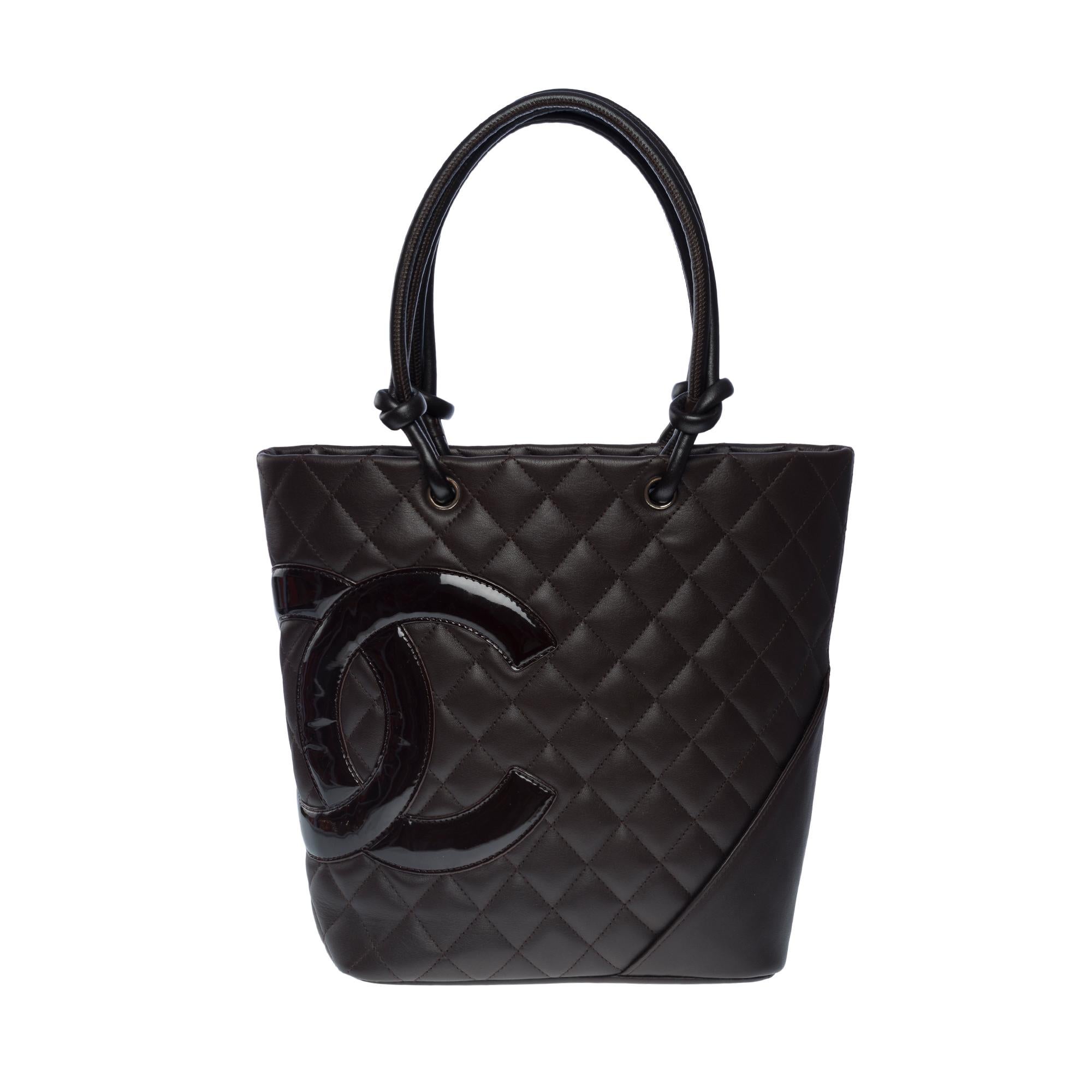 Stunning Chanel Cambon Tote bag in brown quilted lambskin leather, silver metal hardware,
Double brown leather handle for hand or shoulder carry
Zipper
CC brand orange fabric inner lining, two zip pockets, two pen slots, one tie
Signature: