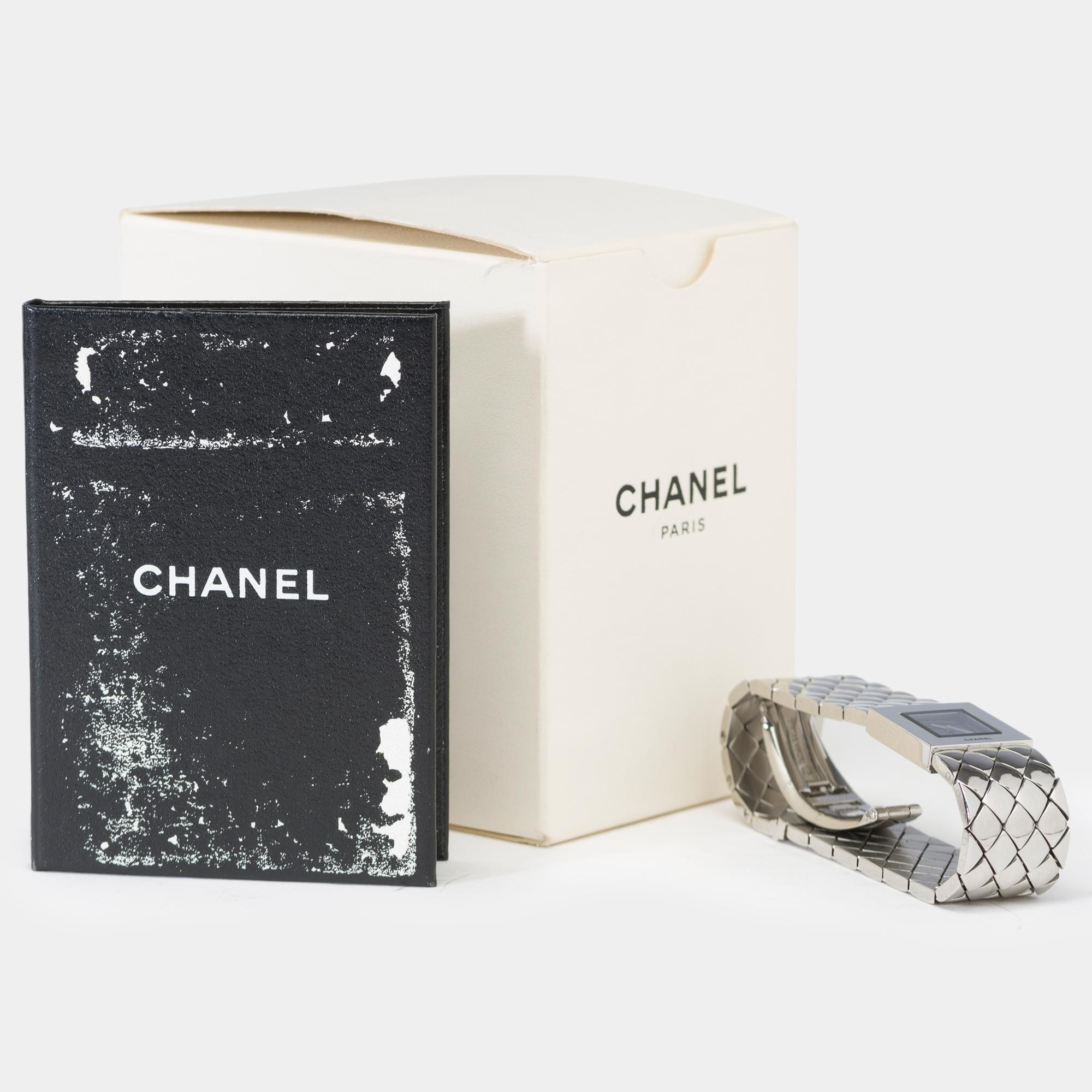Brand:​ ​Chanel
Collection:​ ​Matelassée
Reference:​ ​9000
Dial:​ ​Black​ ​lacquer
Movement:​ ​Quartz
Case:​ ​Steel,​ ​No.​ ​F.E.70649
Dimensions:​ ​19x19​ ​mm
Bracelet:​ ​Steel​ ​with​ ​quilted​ ​design​ ​signed​ ​Chanel,​ ​butterfly​ ​clasp,​