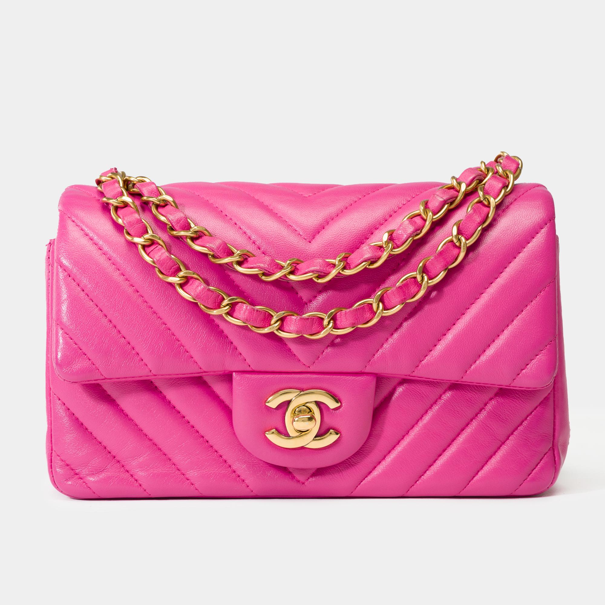 Splendid​ ​Chanel​ ​Mini​ ​Timeless​ ​Chevron​ ​Flap​ ​Bag​ ​in​ ​quilted​ ​pink​ ​lambskin,​ ​featuring​ ​gold-tone​ ​metal​ ​accents.​ ​It​ ​comes​ ​with​ ​a​ ​gold-tone​ ​metal​ ​chain​ ​interwoven​ ​with​ ​pink​ ​leather​ ​for​ ​hand,​