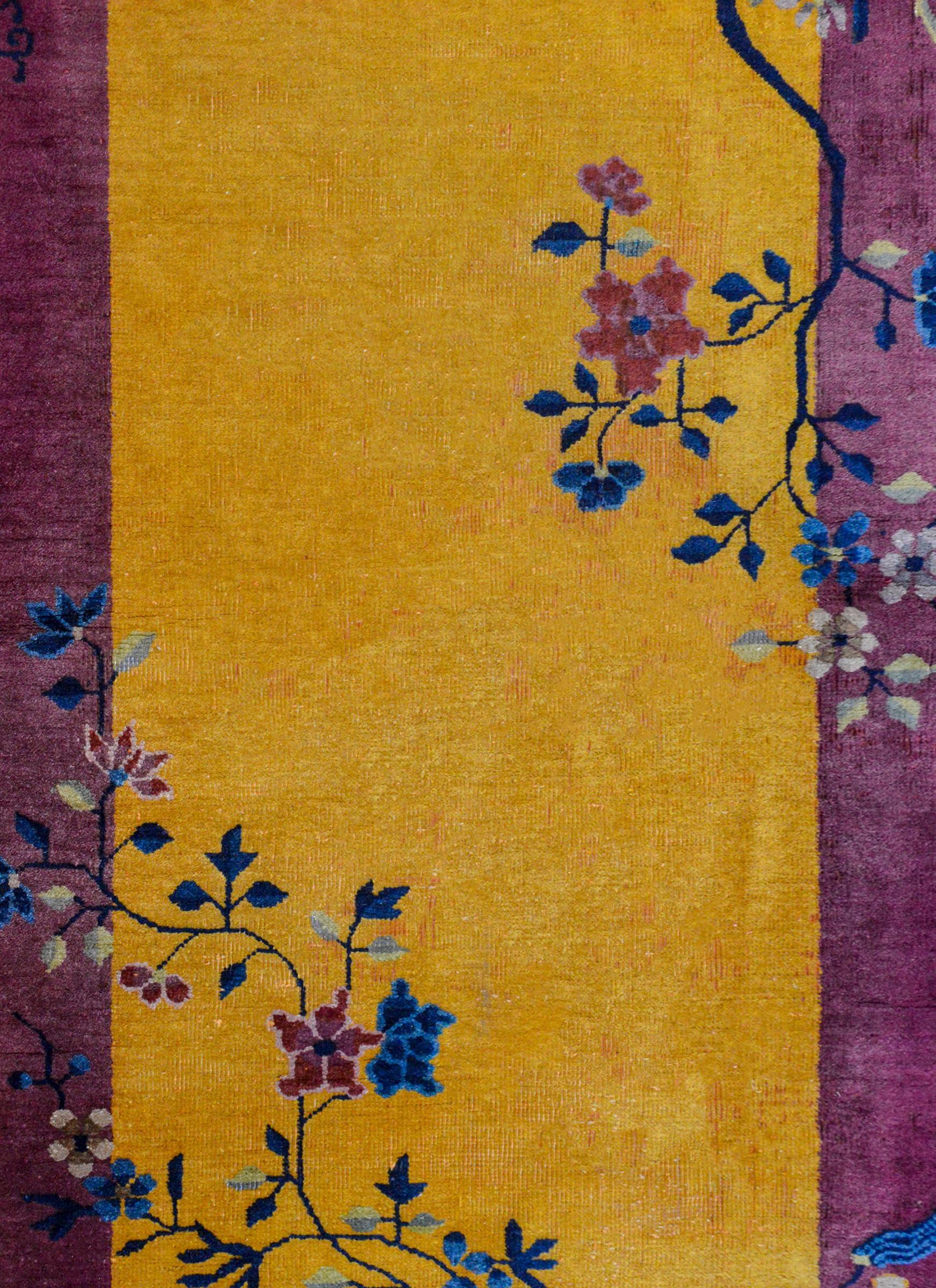 A gorgeous early 20th century Chinese Art Deco rug with a rich goldenrod central field surrounded by a wide violet border, overlaid with multicolored potted prunus, chrysanthemum, and peony plants with auspicious scholar's objects in opposite