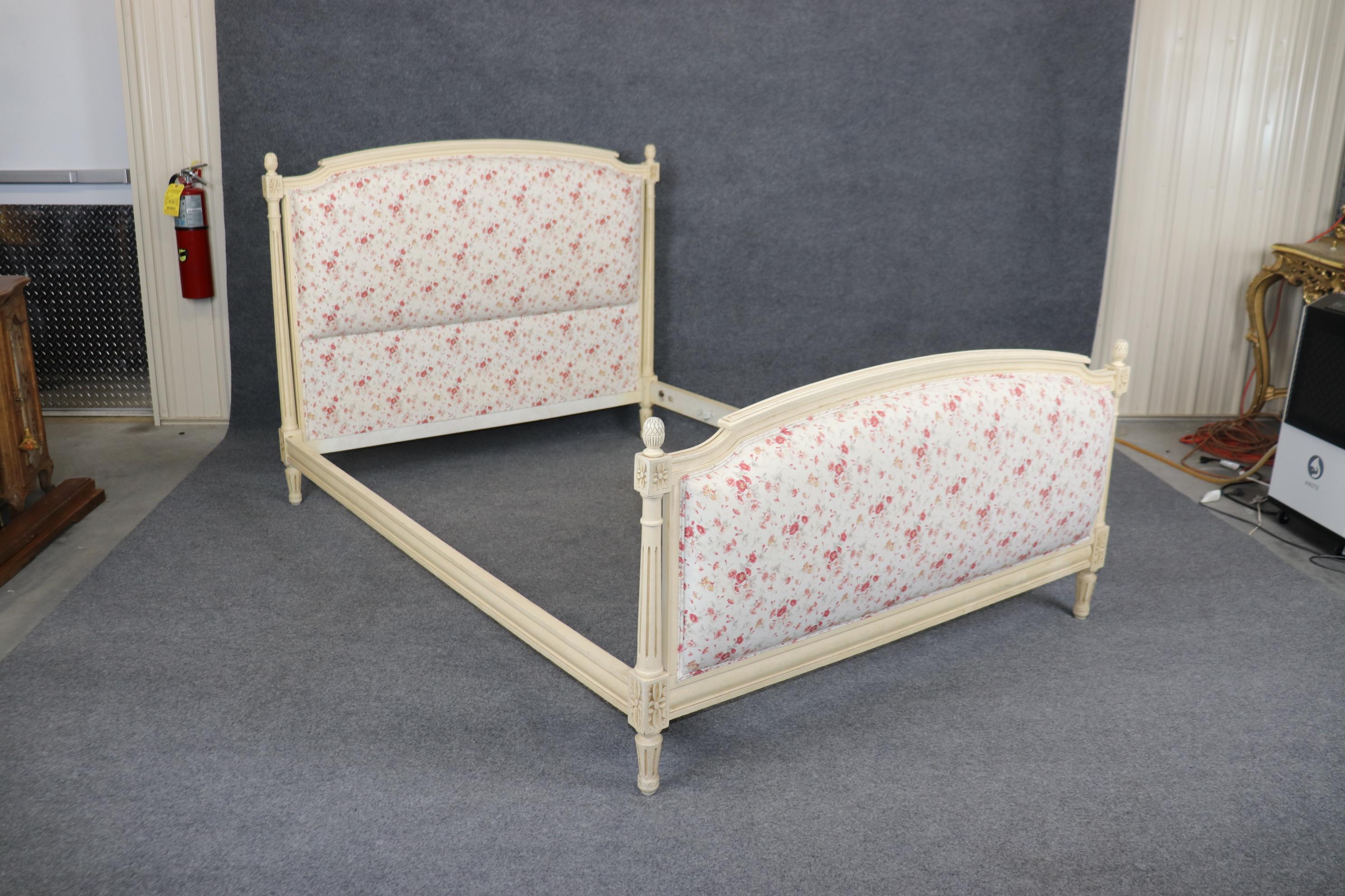 This is a dreamy floral upholstered creme paint decorated genuine French made bed. The bed is a full-size bed and may differ slightly from an American standard size because it's French. The finish is in good vintage condition and the upholstery is