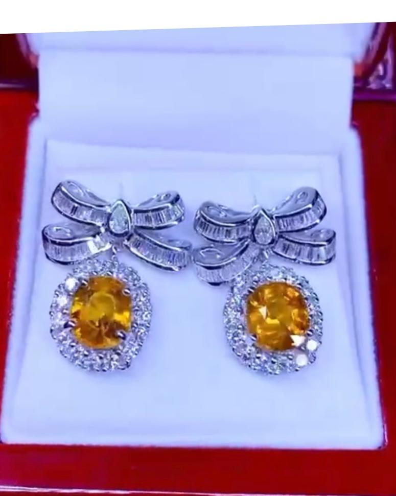 So chic and elegant design for this gorgeous earrings in 18k gold with oval cut orange sapphires 5,66 ct and baguettes and round brilliant cut diamonds 2,45 , F/VS.
Handmade  jewelry by artisan goldsmith .
Excellent manufacture and quality.
Complete