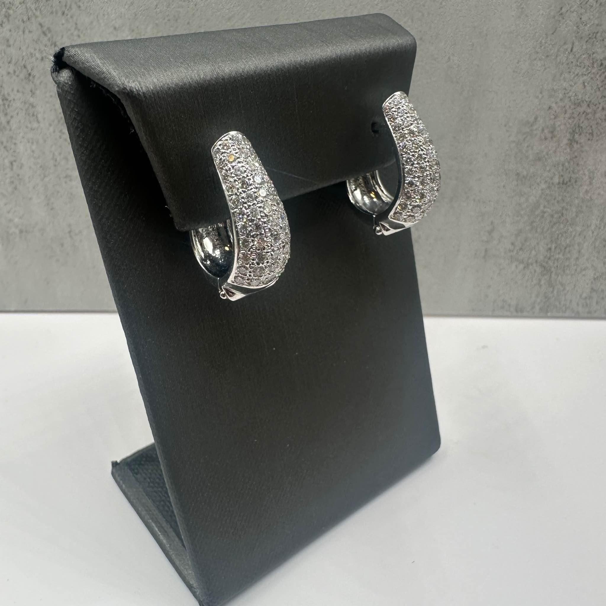 These Gorgeous Diamond Earrings in 18kt white gold feature approximately 3ctw of natural GH VS/SI round diamonds, creating a stunning sparkle. Weighing 14.5 grams, they offer a substantial feel while maintaining comfort for all-day wear. In