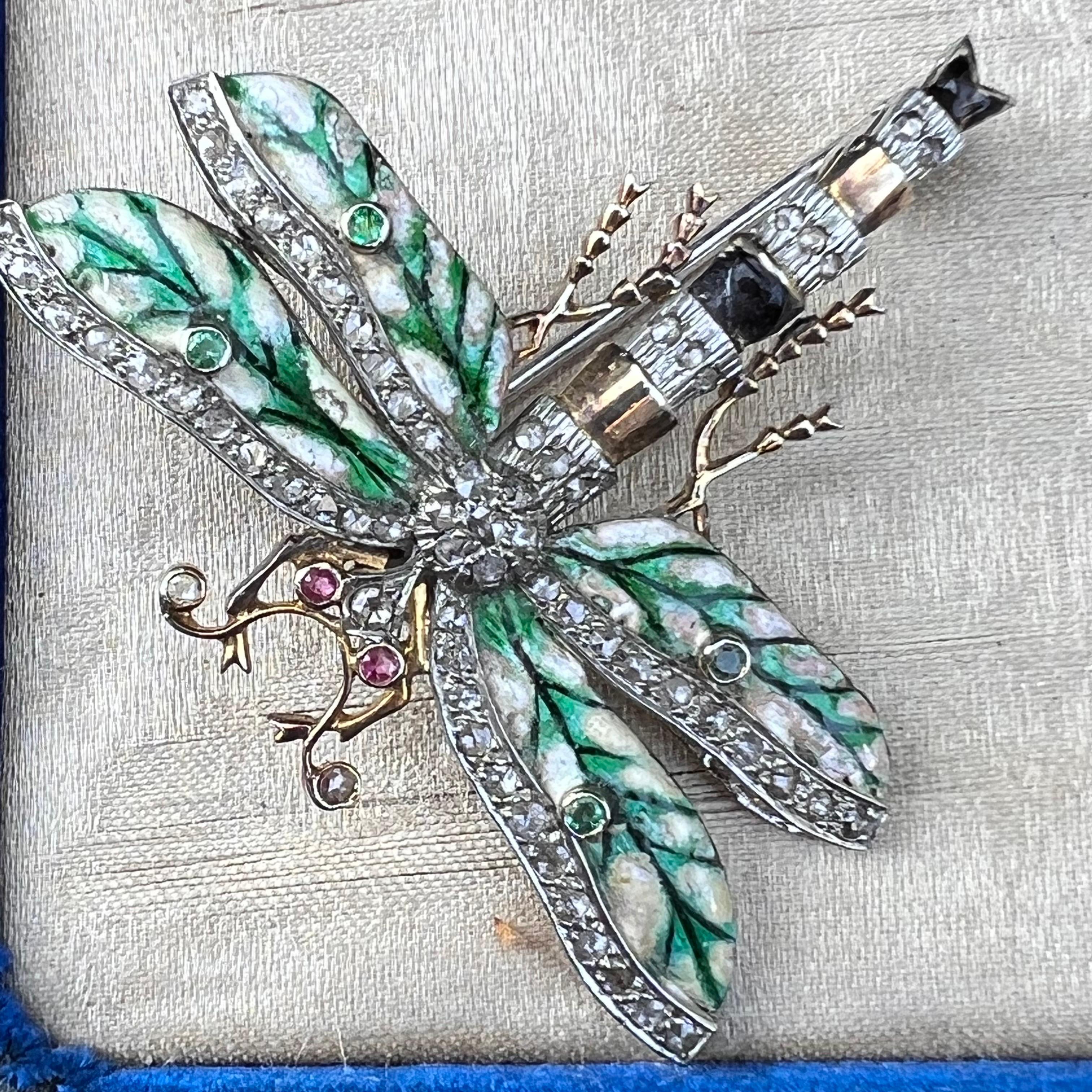 Absolutely stunning details on this large handmade Art Nouveau style dragonfly pin /brooch featuring hand painted enamel wings  with rose cut diamond boarder . Eyes have two genuine rubies mounted in higher grade silver and 14kt gold accents