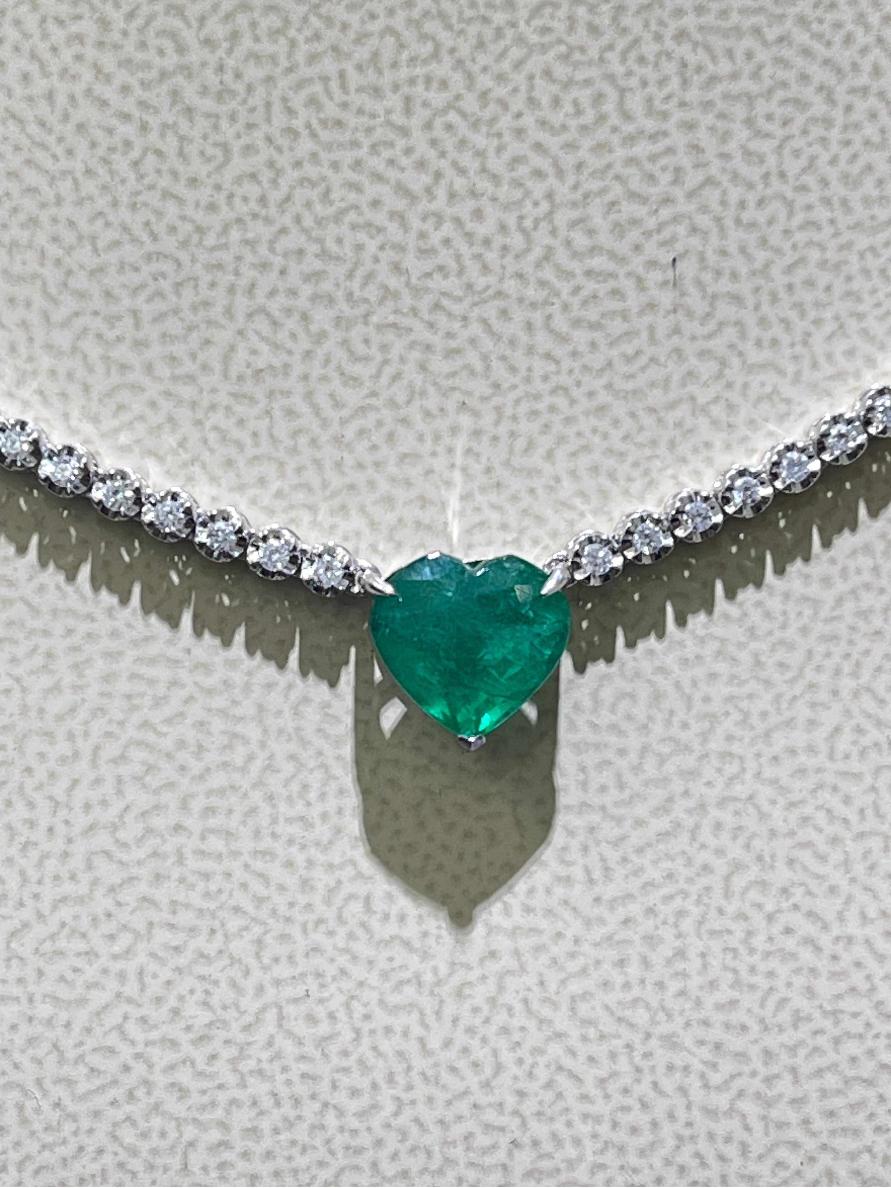 Gorgeous Emerald And Diamond Necklace In 18k White Gold .

- 2.08 diamonds total carat weight,

- 2.73 carats in heart shaped emerald,

- necklace length is 16”