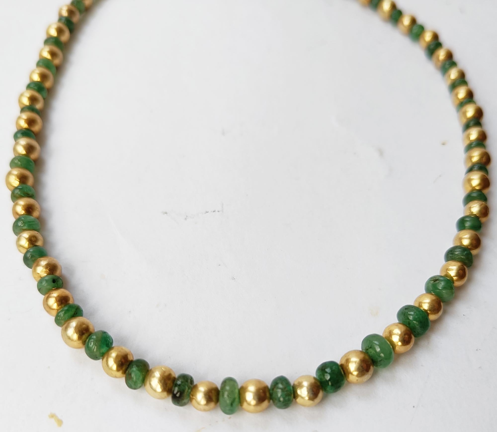 Gorgeous Emerald and gold plated silver beaded necklace
Unfaceted Zambian Emerald beads with gold plated silver beads  
4-5 mm Emerald beads
5 mm gold plated silver beads 
Necklace 16 Inch 40 cm 
All hand crafted with sterling clasp
Simple Elegant