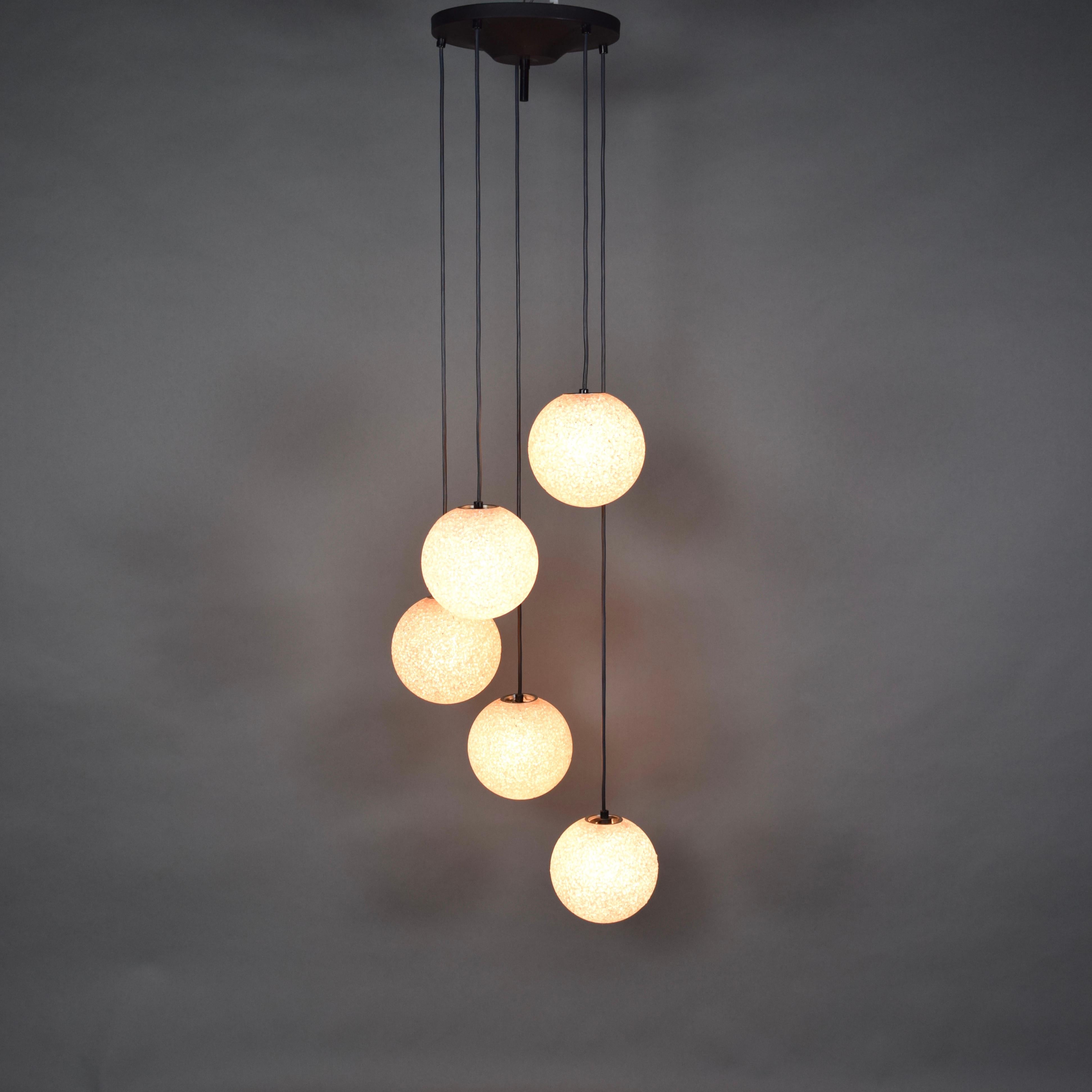 Vintage 1970s Cascade Pendant Light – Space Age Elegance.

Bring retro glamour into your home with this stunning 1970s cascading pendant lamp. Featuring five textured glass globes suspended at varying heights, this hardwired statement piece captures