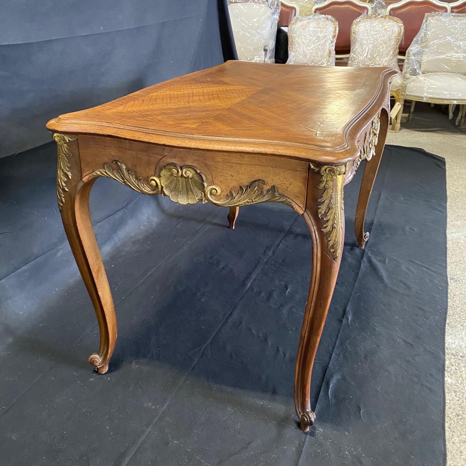Very rare French Louis XV table with original gold gilt paint. Multi functional versatlle stunning accent table, side table or focal point that can also be used as a dining table or desk. Beautifully carved acanthus leaves and other floral details