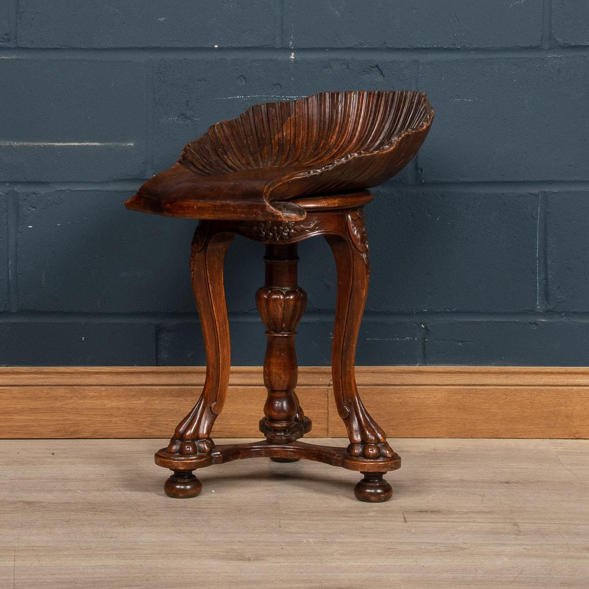 A beautiful carved antique fruitwood grotto stool, the bench standing on cabriole legs joined with a bottom stretcher, and bun feet reminiscent of animal paws, made in Venice around the turn of the 19th century. The seat has a 