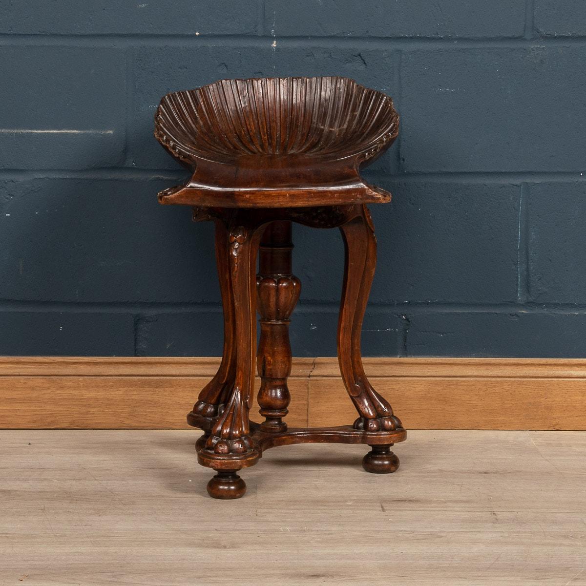 A beautiful carved antique fruitwood grotto stool, the bench standing on cabriole legs joined with a bottom stretcher, and bun feet reminiscent of animal paws, made in Venice around the turn of the 19th century. The seat has a 