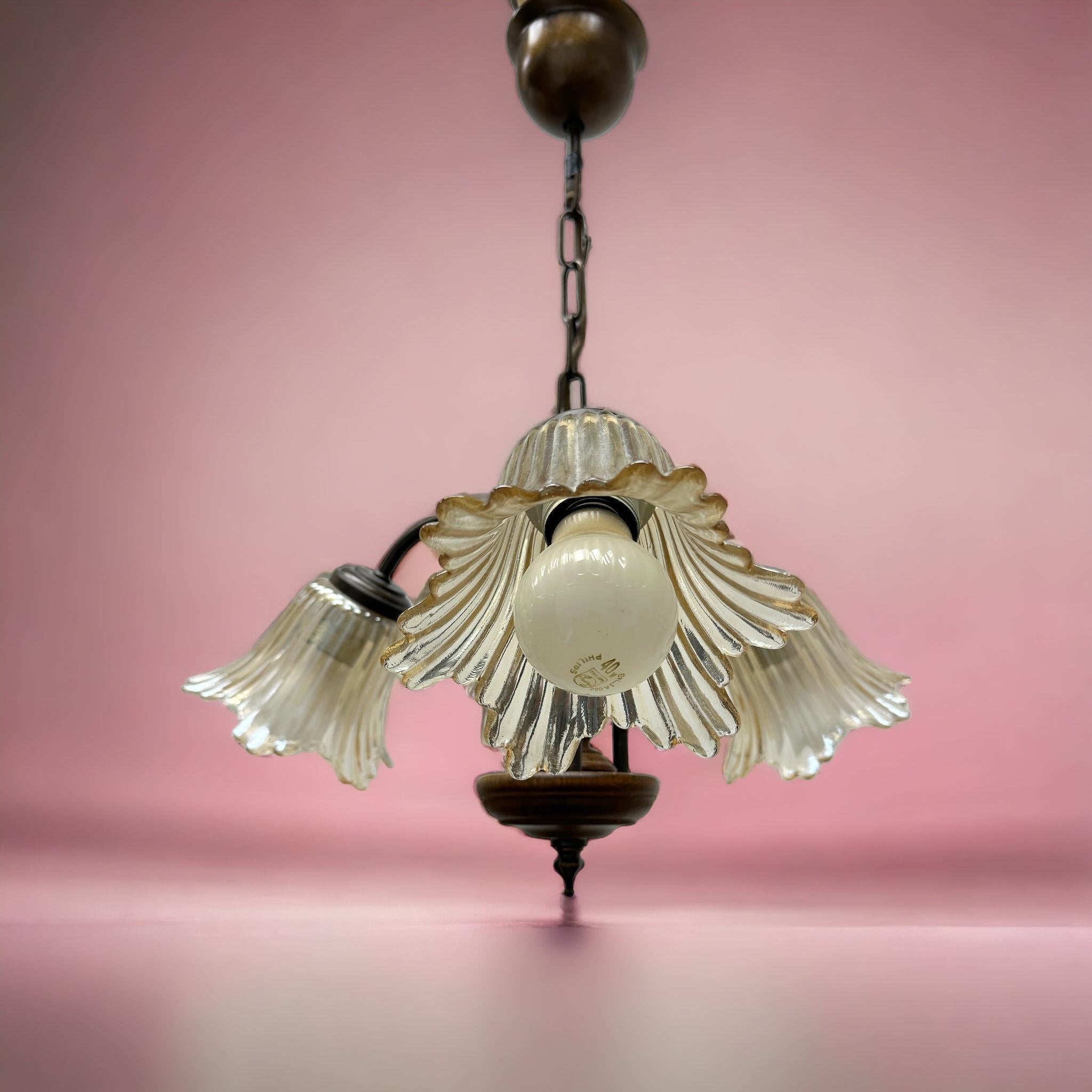 Petite Florentine style three-light chandelier. Functions as is with three E27 / 110 Volt light bulbs. Can take up to 60 Watts each bulb. Beautiful metal chandelier with flower glass shades. It gives a very warm light and represents the Italian