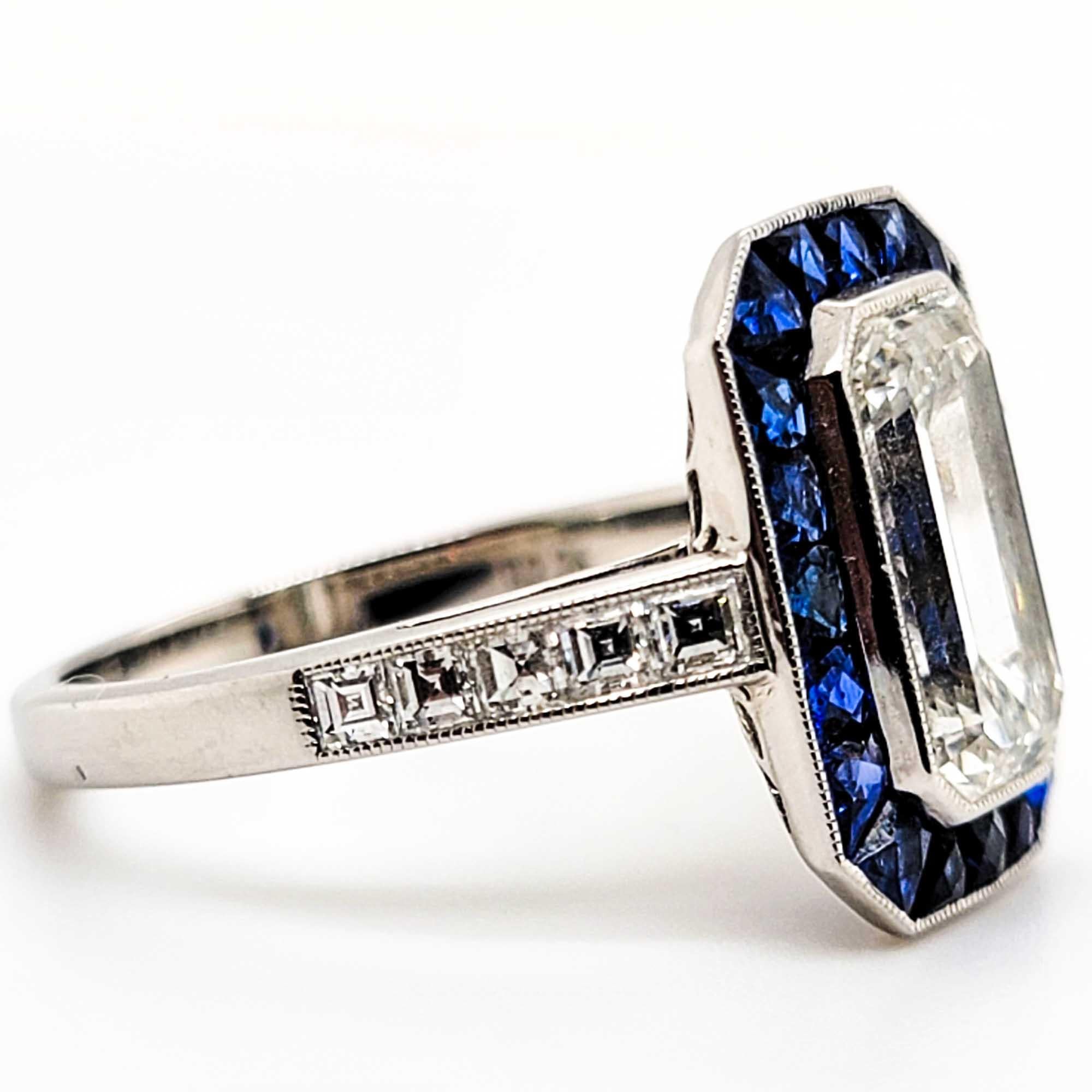 Elegant platinum GIA certified2.26 carat center emerald cut diamond with a color and clarity of H-VVS1 surrounded with sapphire weighing 1.10 carats and diamonds weighing 0.35 carats ring.

